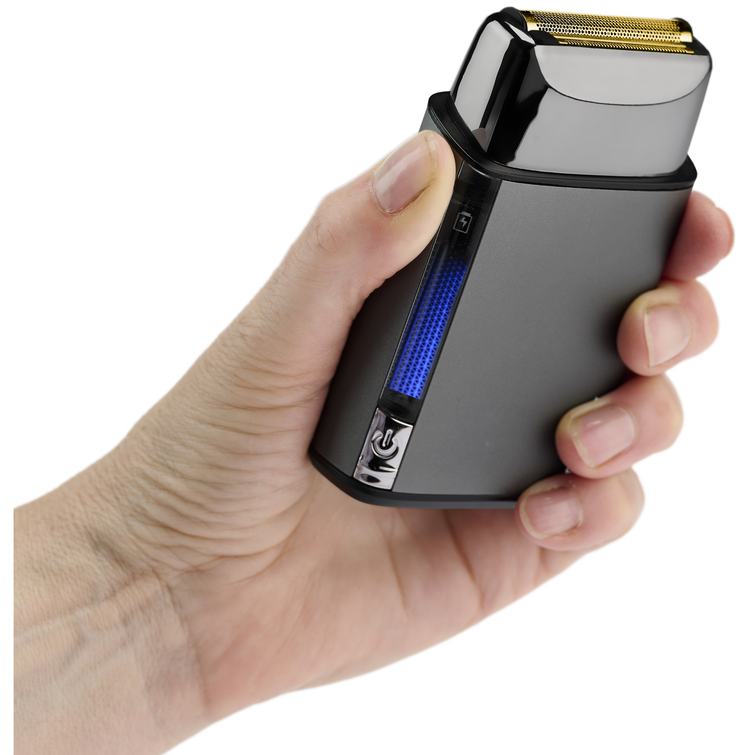 A hand holds a dark travel razor with a gold foil head and blue charge indicator light.