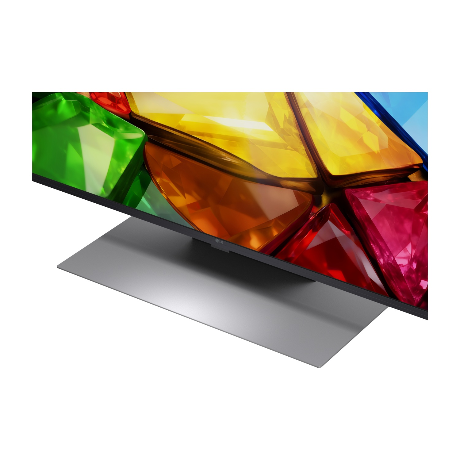 Una TV moderna con motivo geometrico colorato sullo schermo, con supporto argentato.