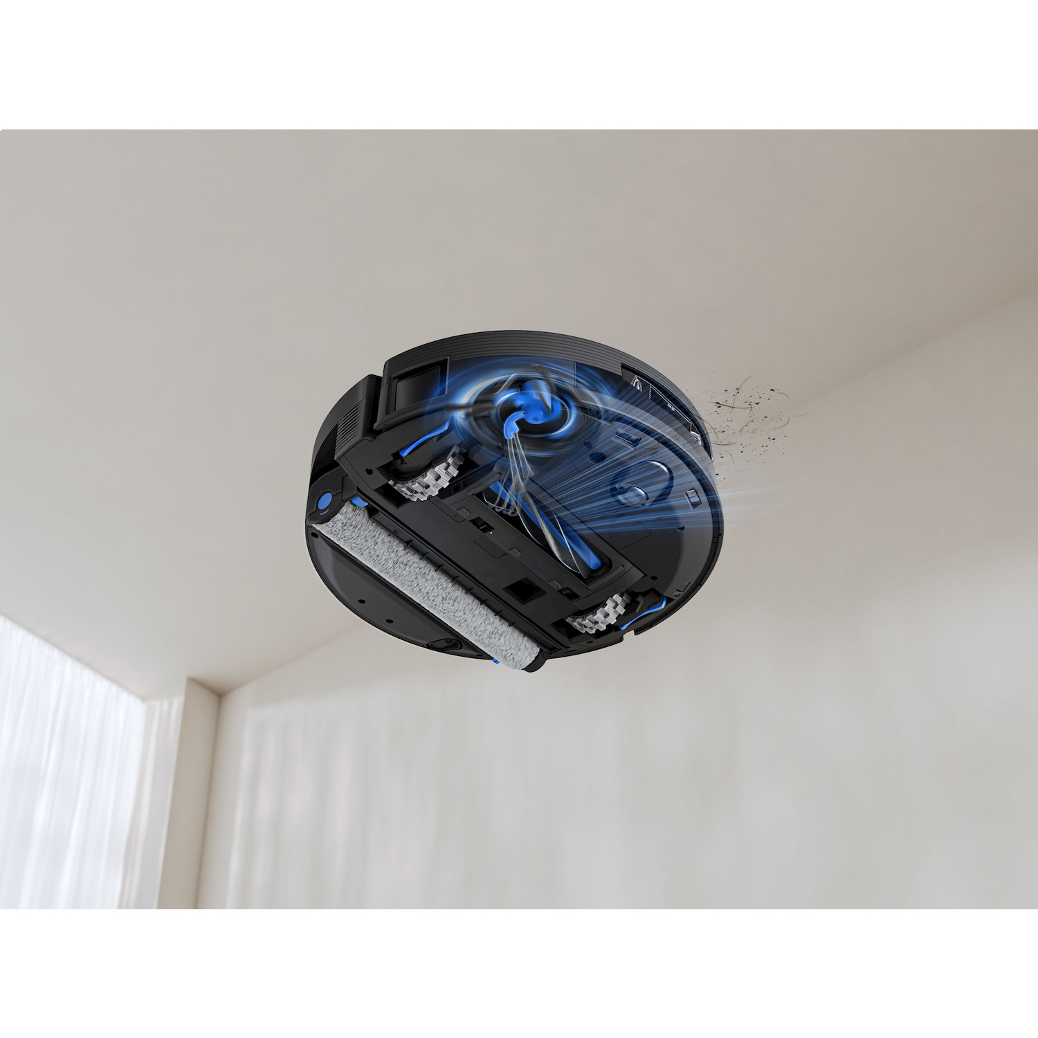 Un robot aspirapolvere nero pulisce polvere e peli con flussi di aspirazione blu.
