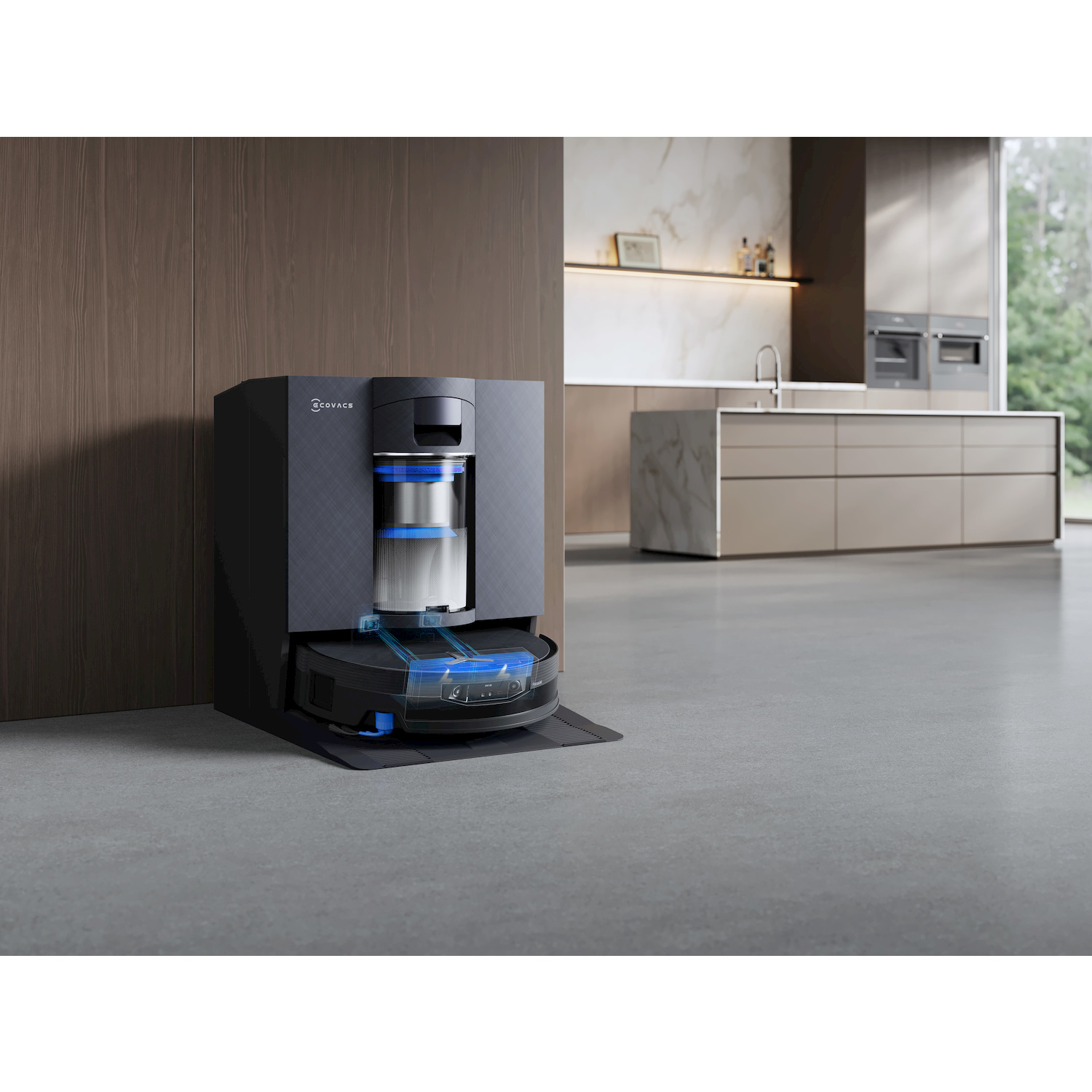 Un robot aspirapolvere con la sua docking station su un pavimento grigio accanto a una cucina moderna.
