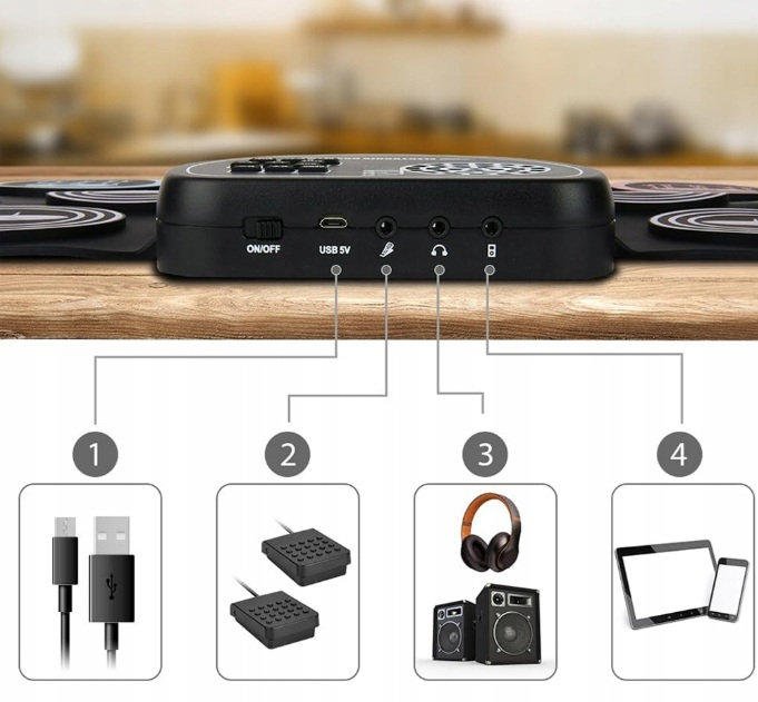 Elektroniczny zestaw perkusyjny z kablem USB, pedałami, głośnikami, słuchawkami, tabletem i telefonem.