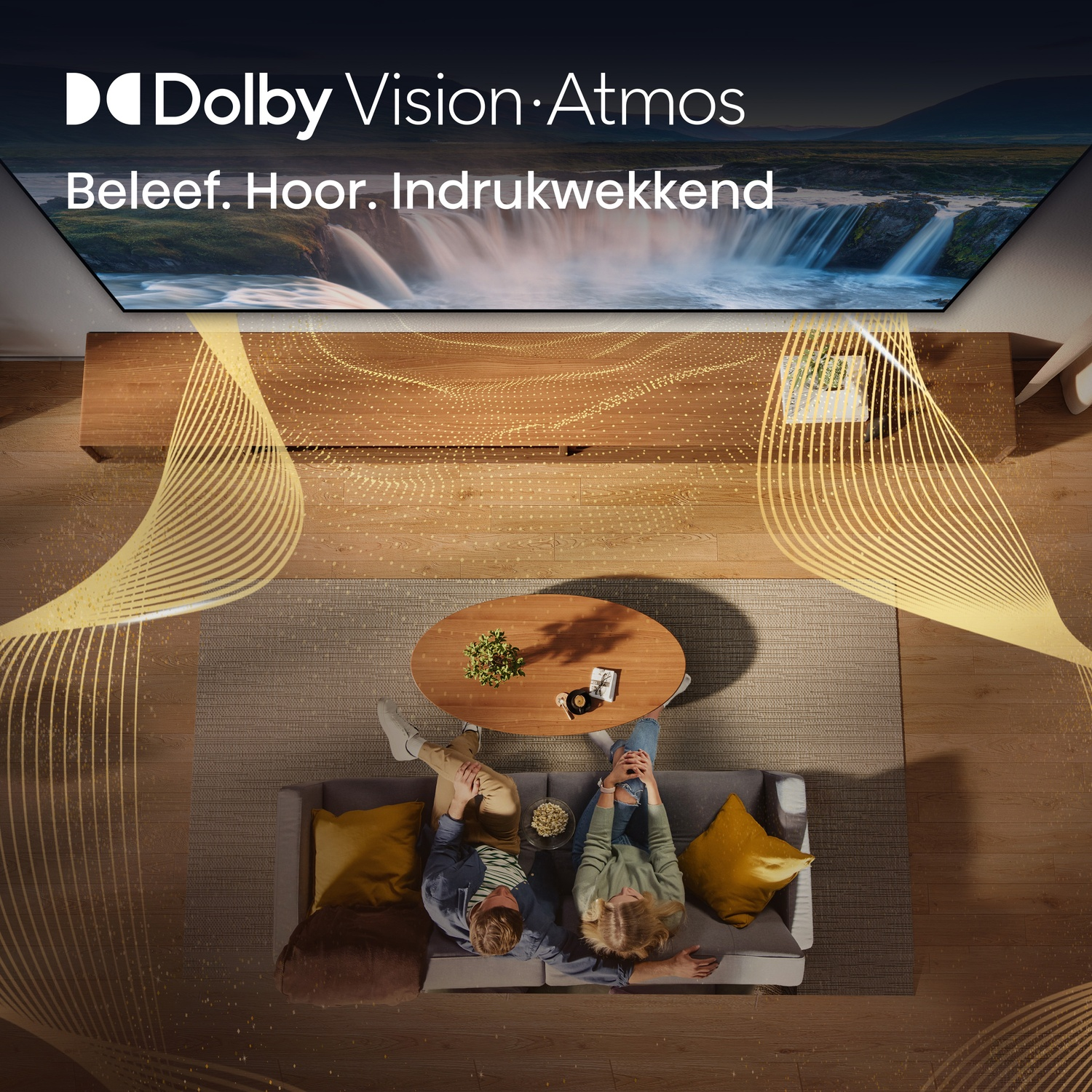 Couple on sofa facing Dolby Vision/Atmos TV displaying waterfall.