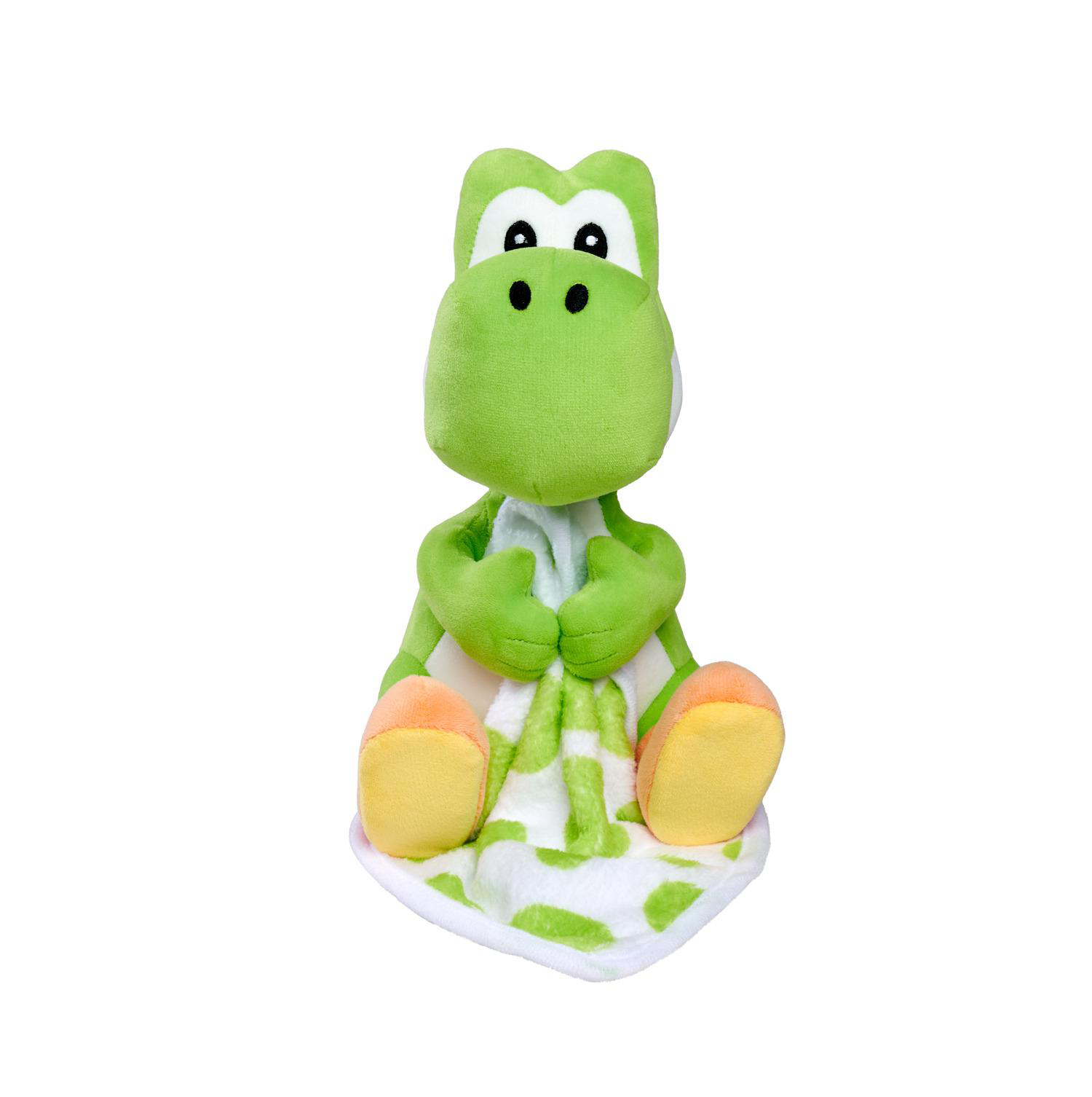Eine grüne Yoshi-Plüschfigur sitzt mit einer Decke mit weiß-grünem Muster.