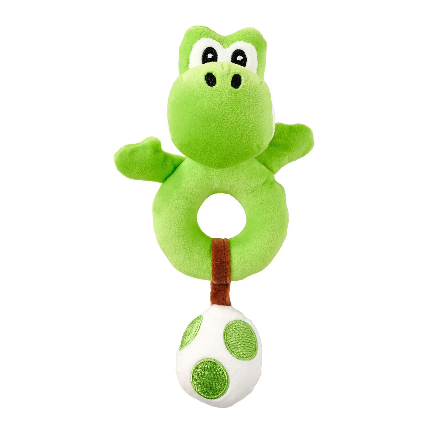 Ein grünes Yoshi-Plüschtier mit einem Ring und einem Ei. Weißer Hintergrund.