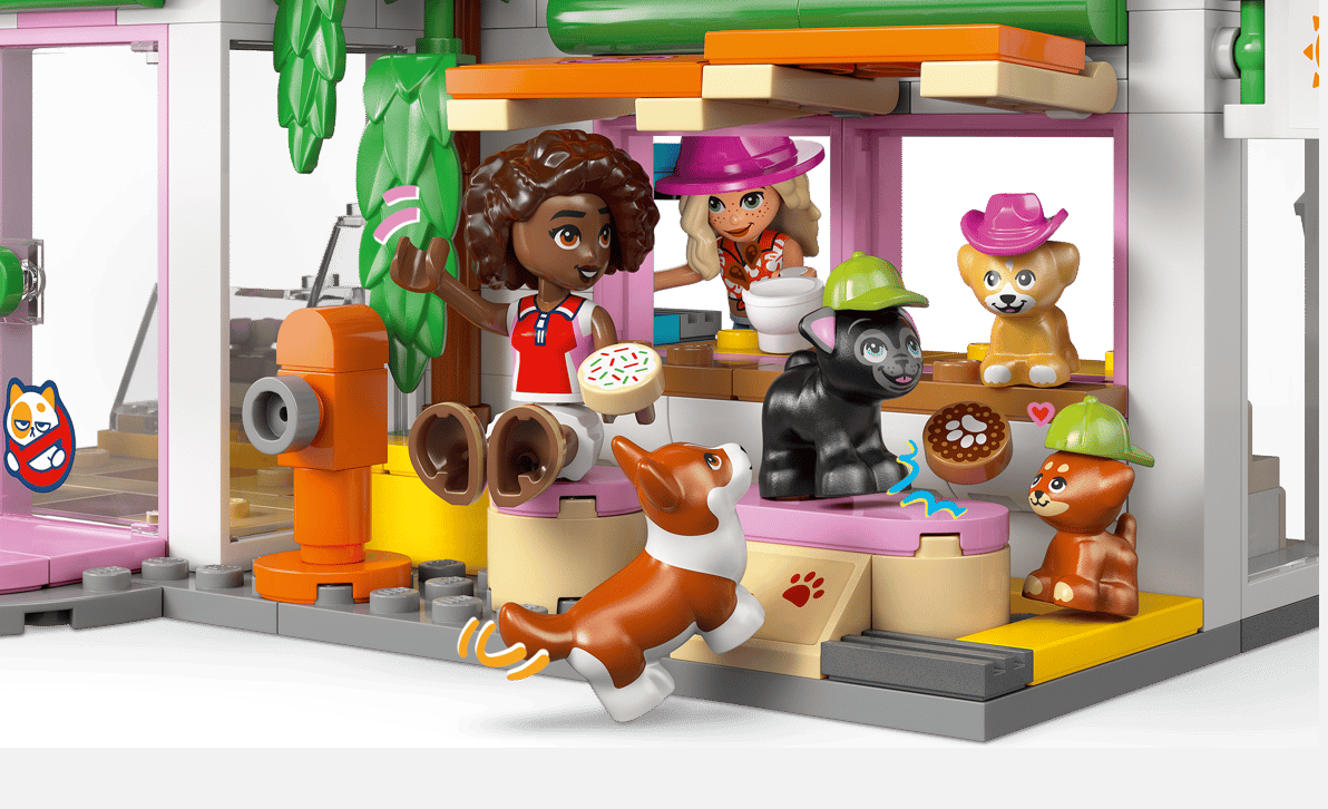 Lego-Figuren von zwei Mädchen und vier Tieren in einem Haus mit Hydrant.