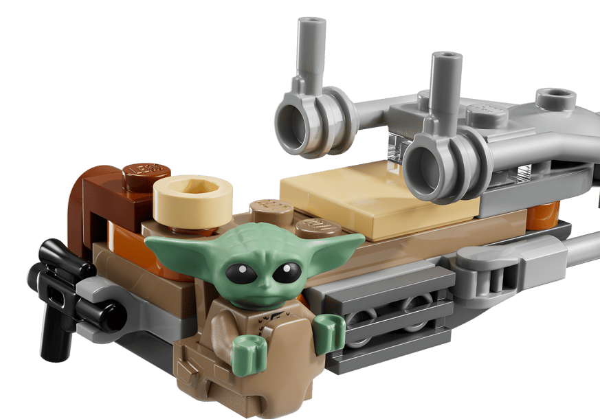 Grüne Lego-Figur mit großen Ohren sitzt auf einem braunen Gefährt mit grauen Teilen.