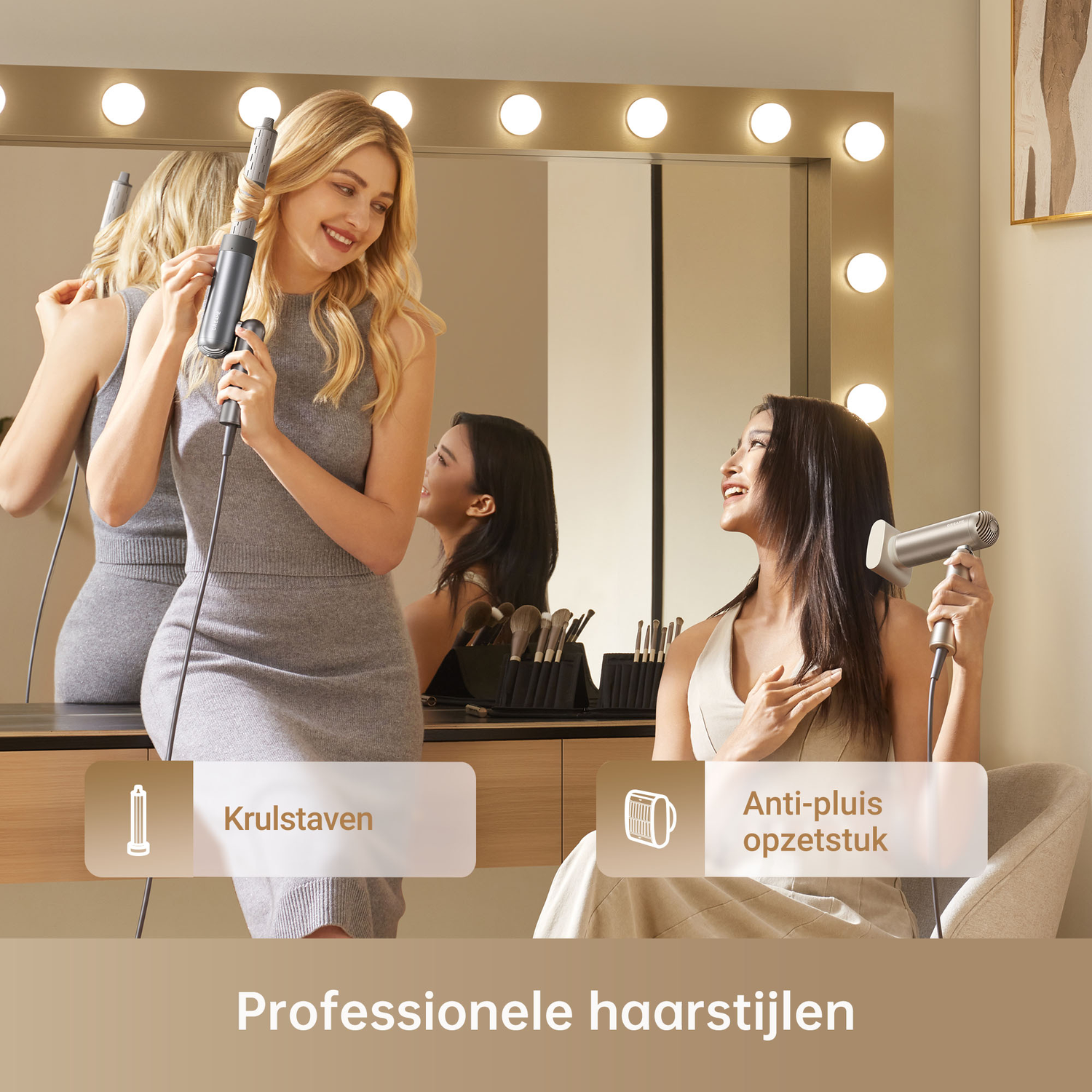 Two women styling hair in front of a lighted mirror. One uses a curling iron, the other a hairdryer.