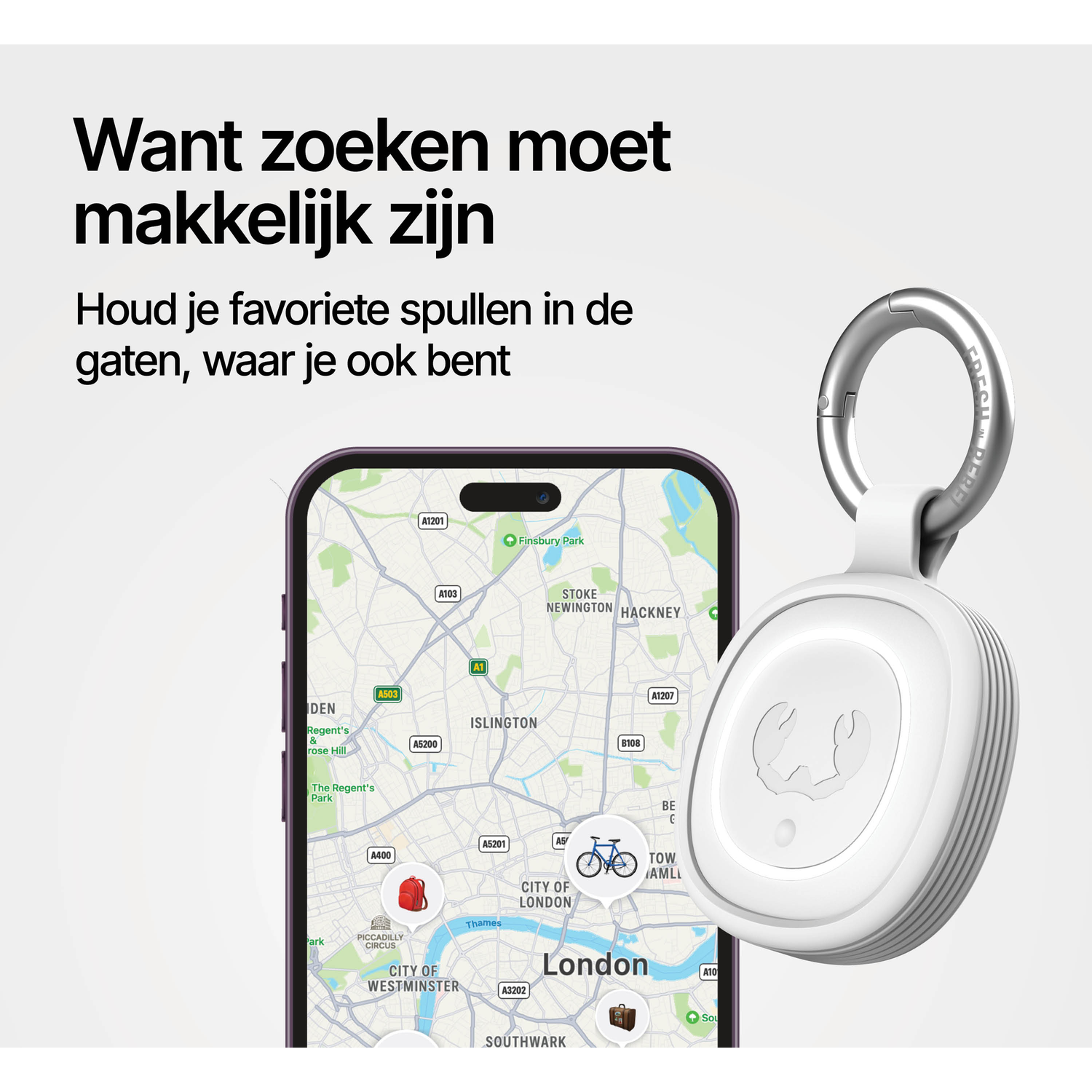 A white tracker with a carabiner clip next to a smartphone displaying a map of London.