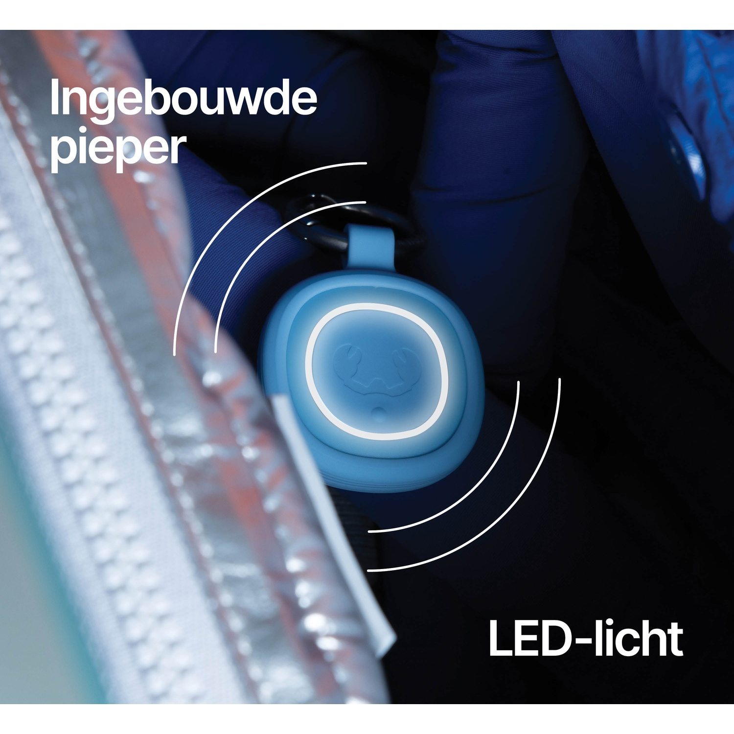 Blue tracker with LED light and beeper function inside a bag.