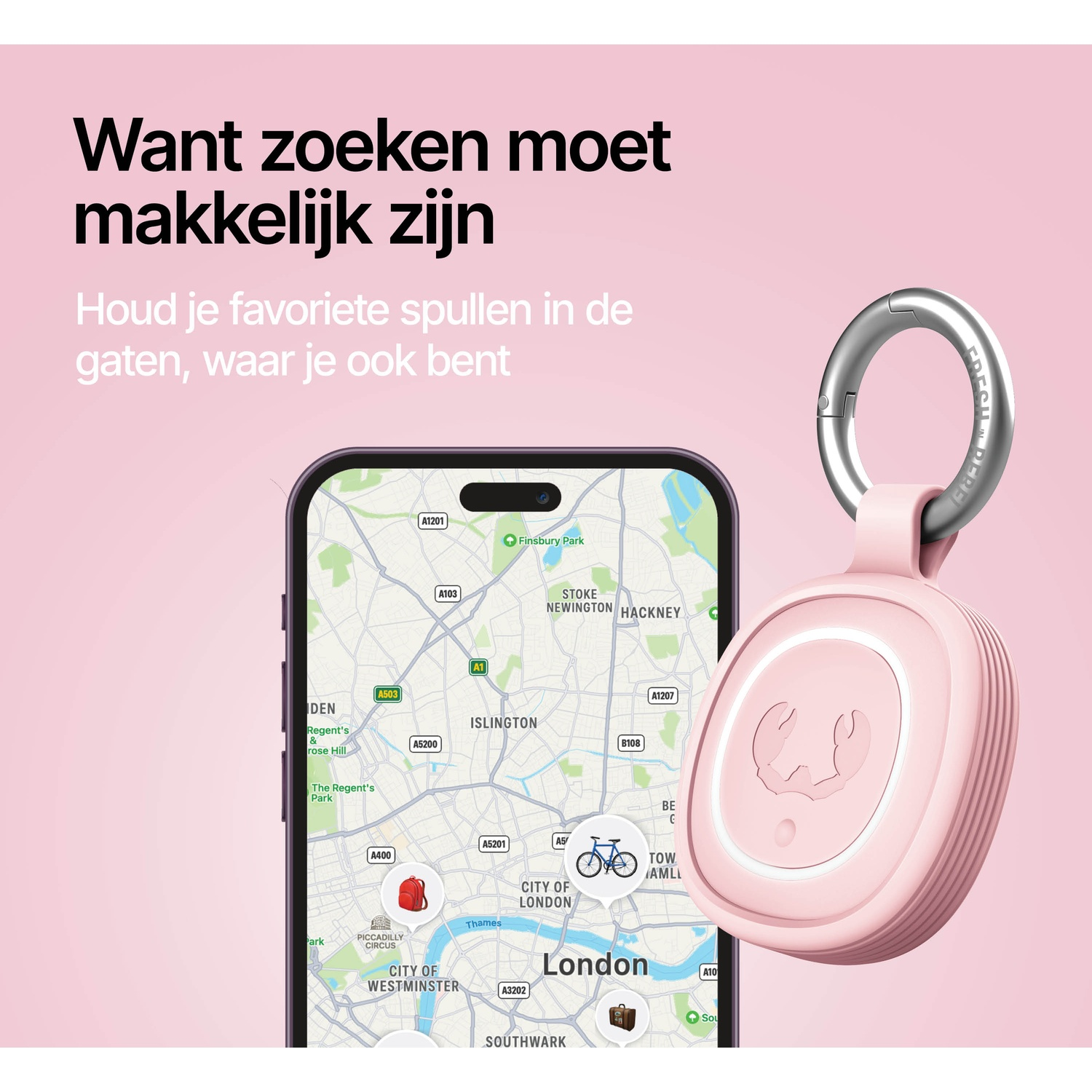 A pink tracker with a keyring next to a phone displaying a map of London.