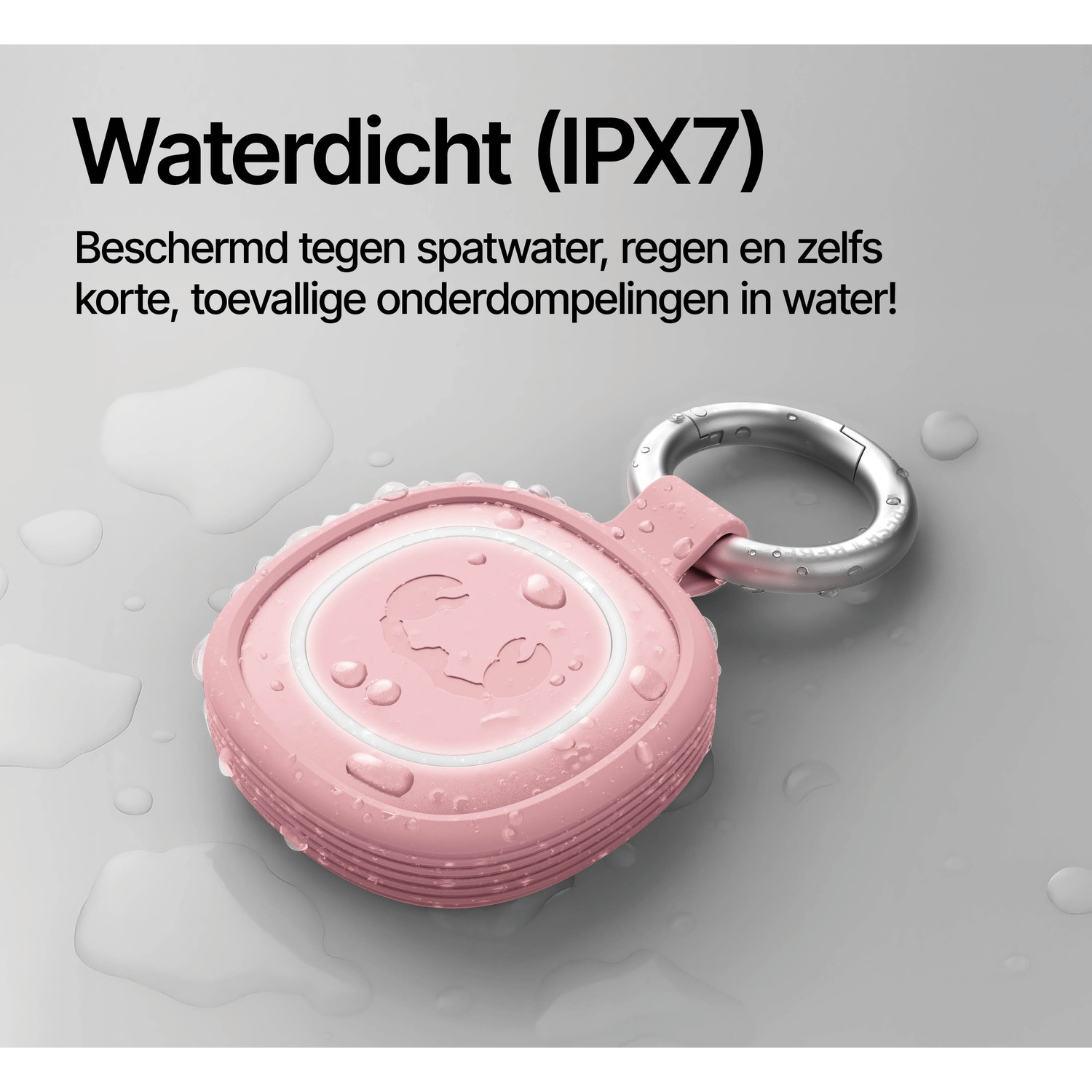 Pink waterproof speaker with a metal loop, covered in water droplets.
