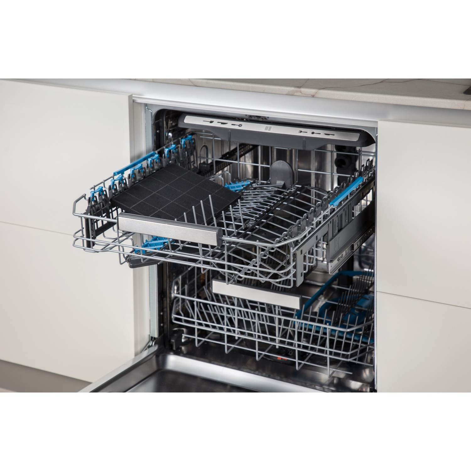 An open dishwasher with pull-out racks, filled with dishes and a filter.