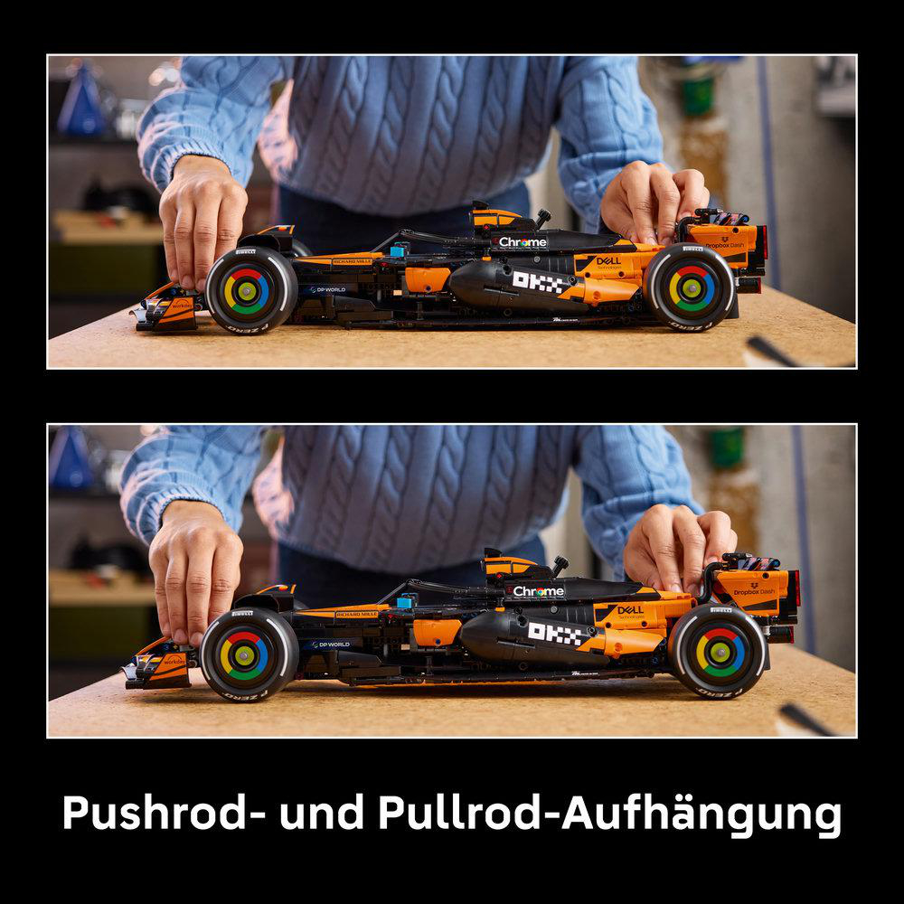 Ein Lego-Formel-1-Auto mit orangefarbenen und schwarzen Akzenten steht auf einem Tisch.