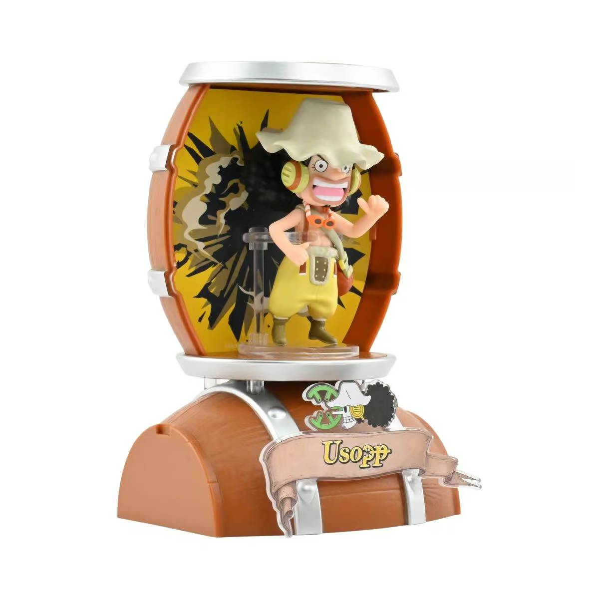 Una pequeña figura de Usopp en un barril, con ropa amarilla y sombrero.
