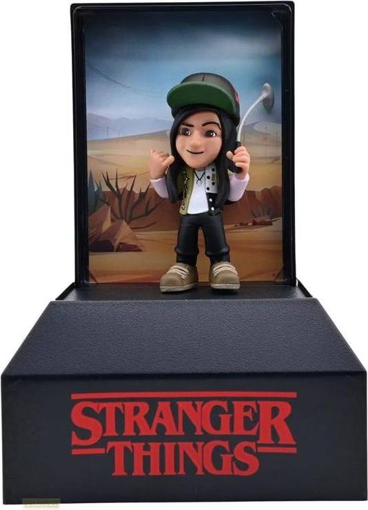 Figura con gorra y caña de pescar en paisaje desértico, logo STRANGER THINGS en la base.