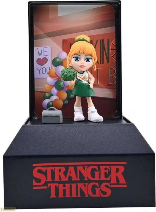 Una figura de Stranger Things de una animadora con globos y una bolsa.