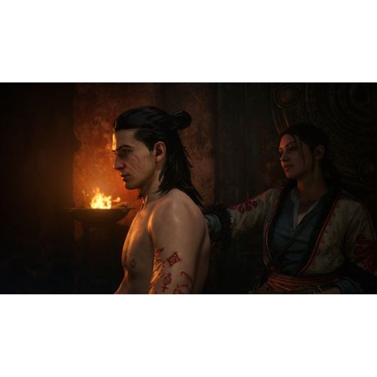 Man with tattoos next to woman in kimono, in front of a fire.