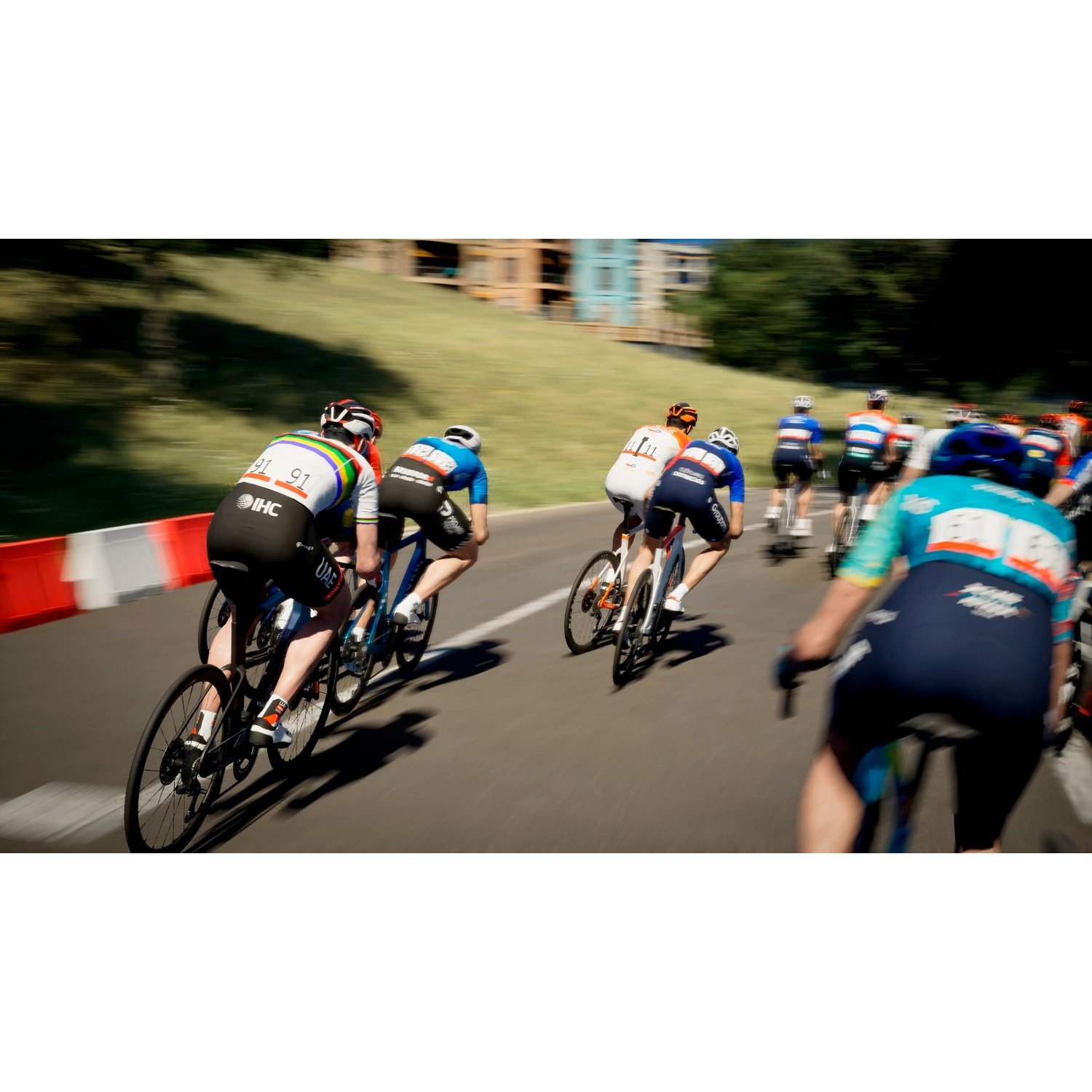 Cyclists in full race, some in colorful jerseys, on an asphalt road.