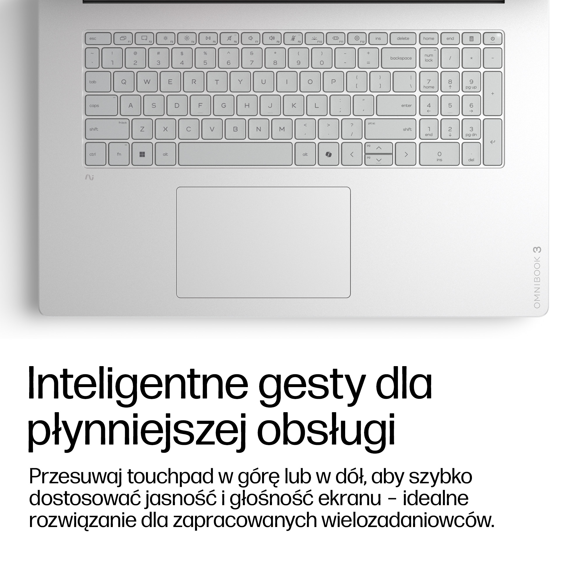 Srebrny laptop z klawiaturą i touchpadem. Tekst: Inteligentne gesty dla płynniejszej obsługi.