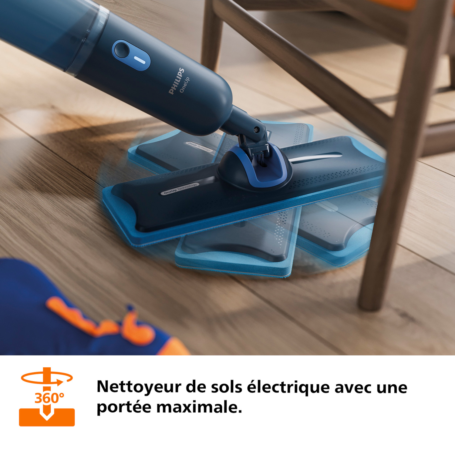 Un nettoyeur de sol Philips bleu avec tampons rotatifs sur un plancher en bois.