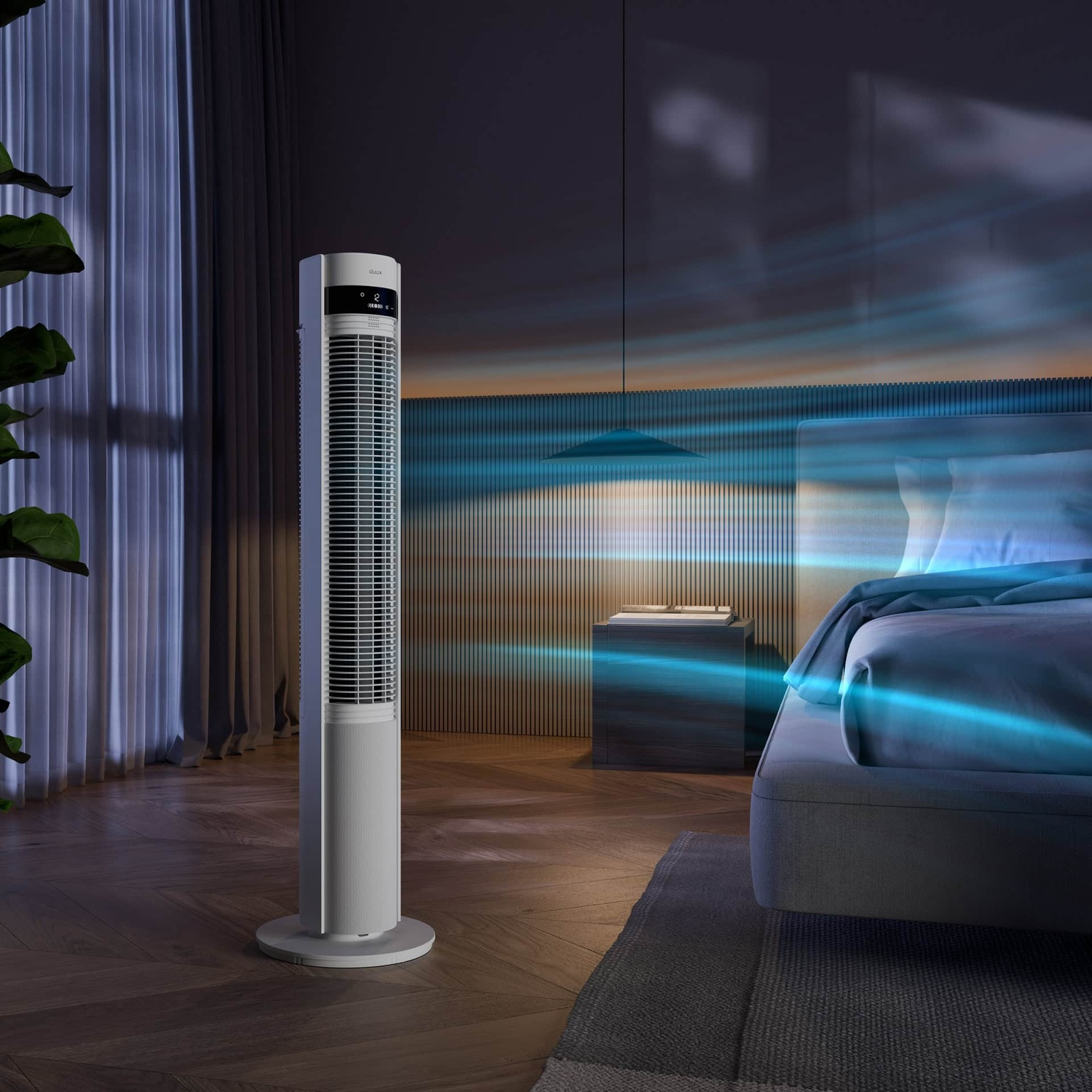 Un ventilateur tour blanc et fin à côté d'un lit. Des courants d'air bleus vont du ventilateur vers le lit.