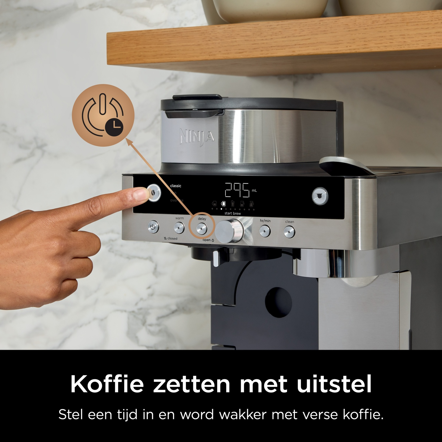 A hand presses a button on a Ninja coffee maker with a digital display.