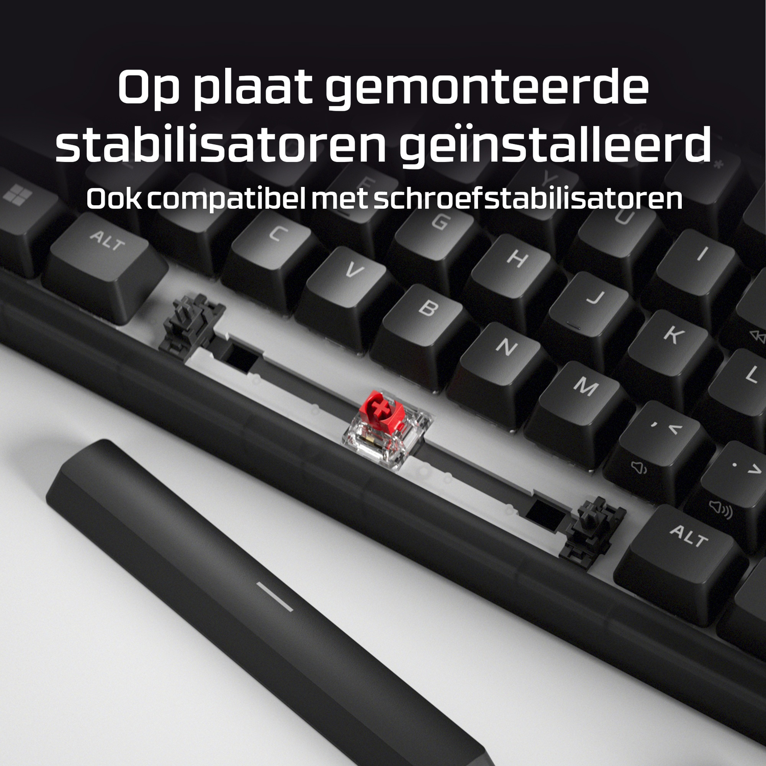Close-up of a keyboard with red switches and a removed keycap.