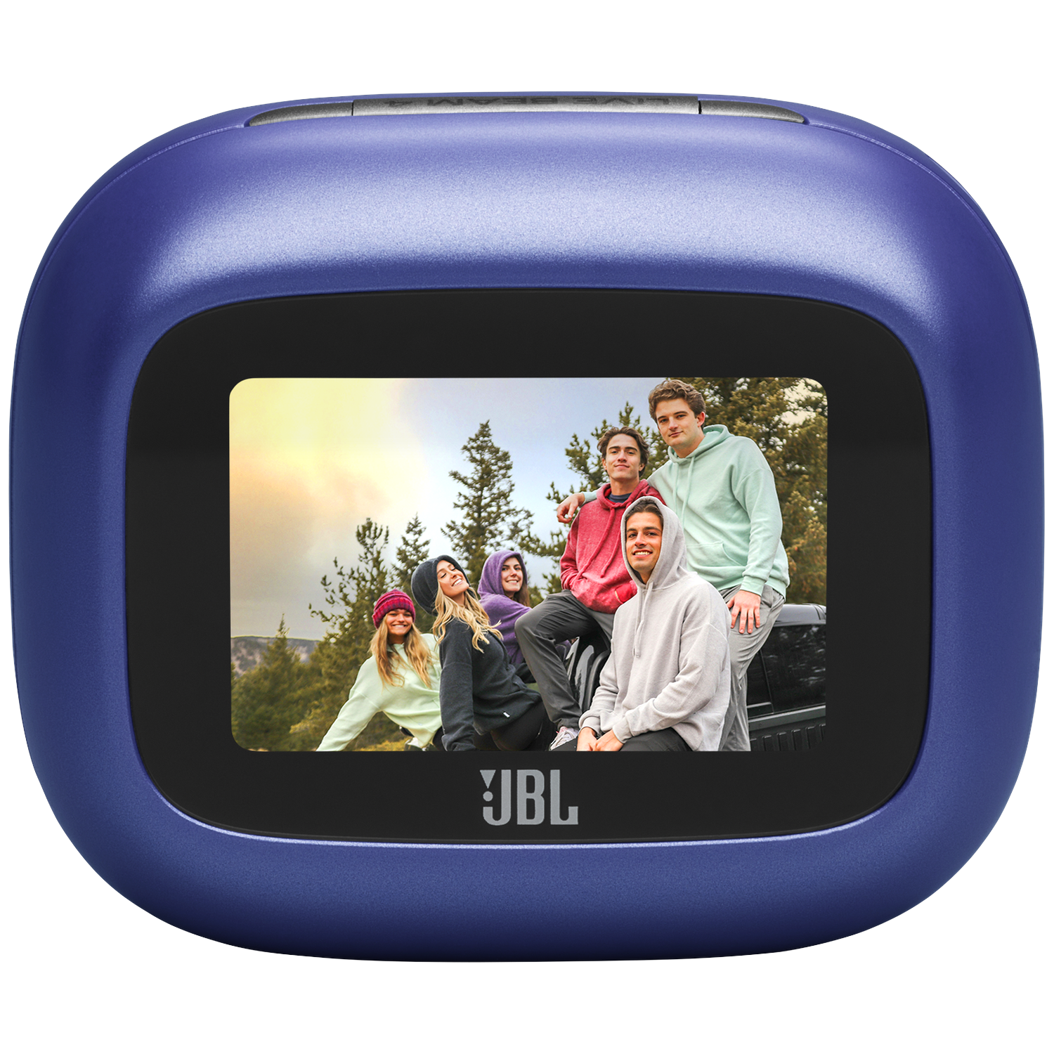 Five young people are sitting on a car in front of trees.