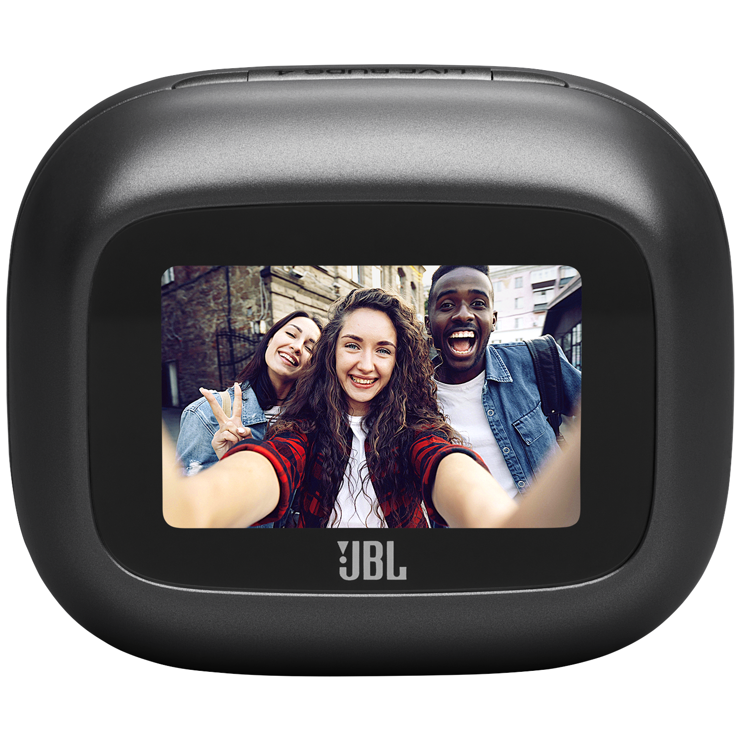 Three young people take a selfie in front of a brick building.