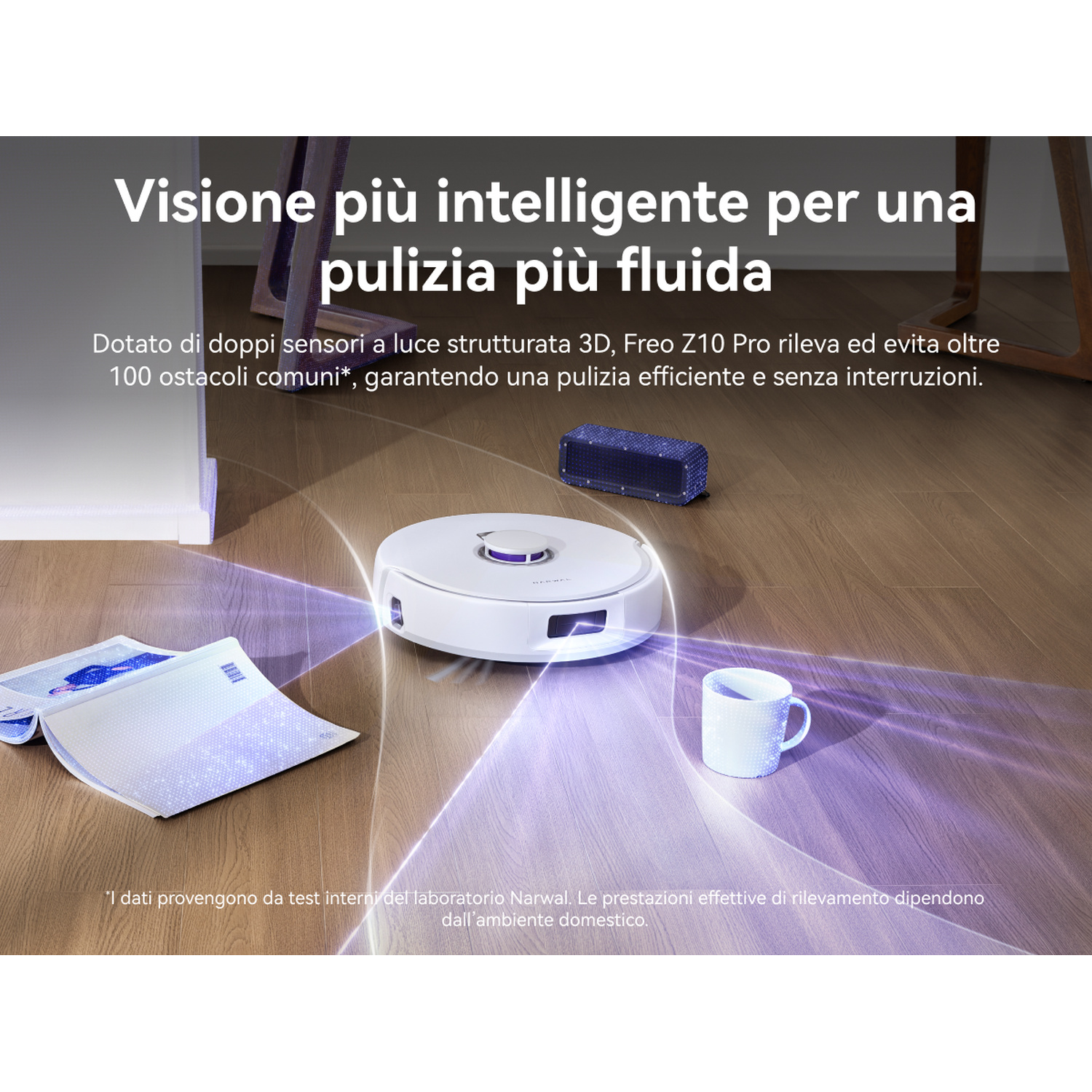 Un robot aspirapolvere bianco naviga su un pavimento in legno con raggi di luce, passando un libro e una tazza.
