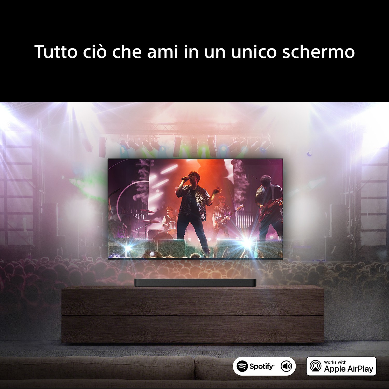 Uno schermo TV mostra una band sul palco con luci e pubblico.