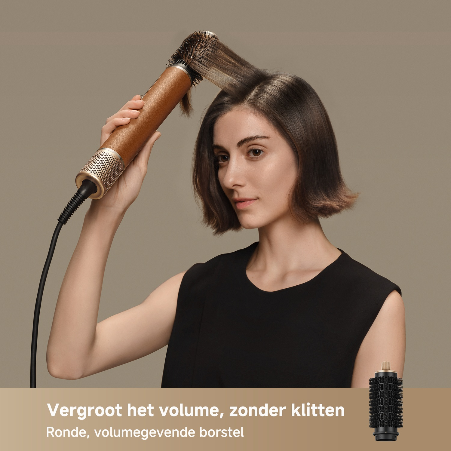 A woman styles her hair with a golden curling iron and a round brush attachment.
