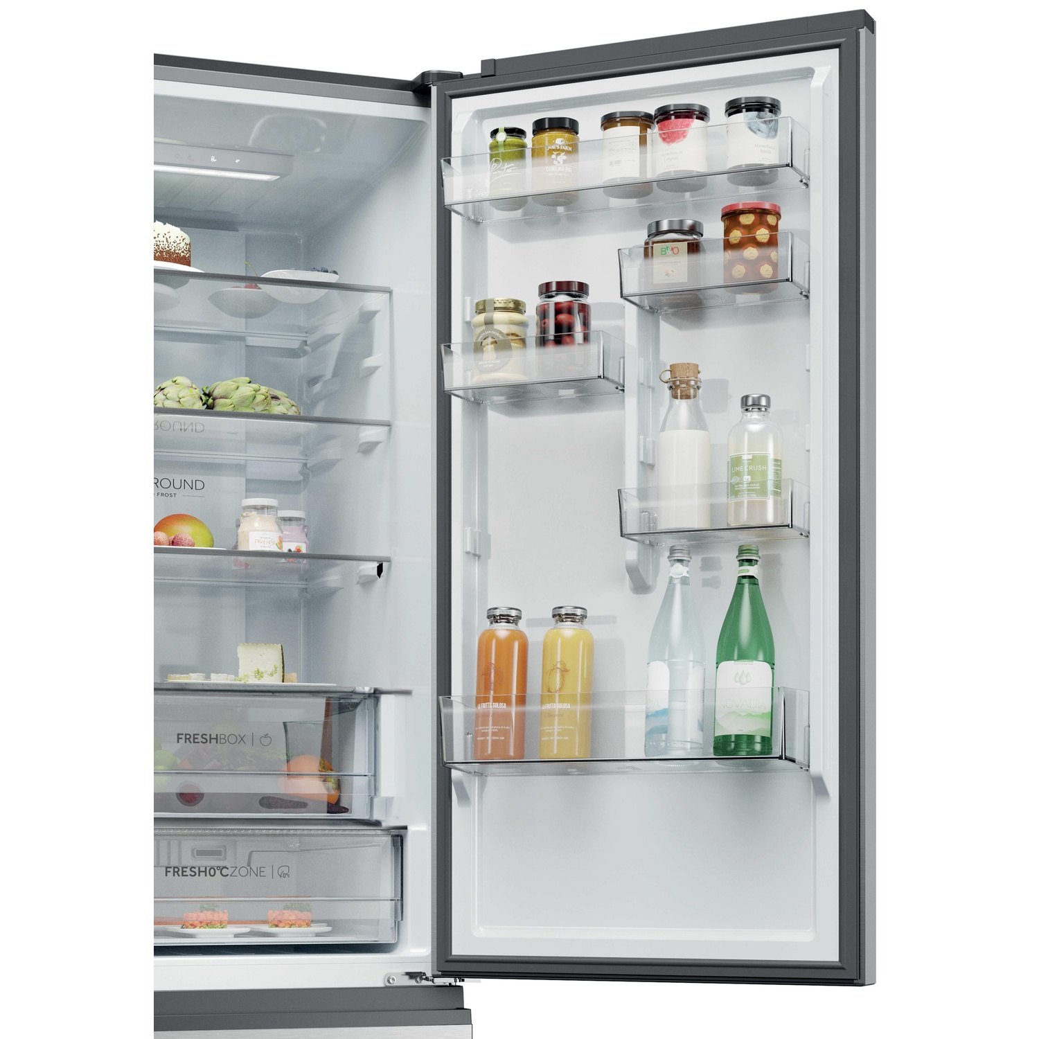 Open refrigerator with shelves stocked with jars, bottles, fruits, and cake.