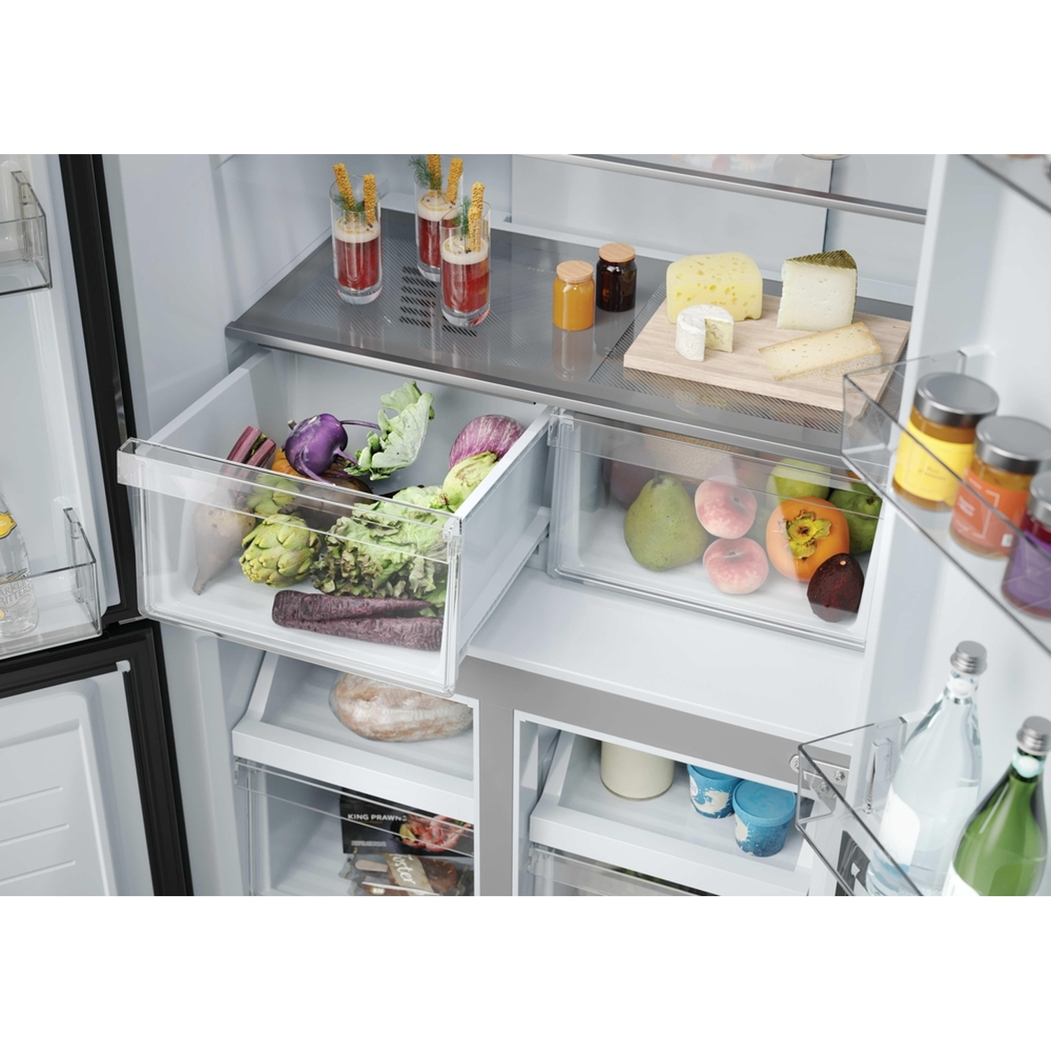 Refrigerator interior with open drawers containing vegetables, fruits, and drinks.
