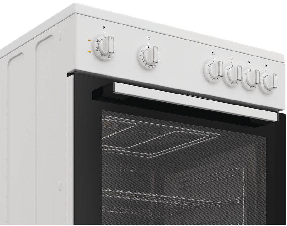 Gros plan d'une cuisinière blanche, porte ouverte, montrant grilles et boutons.