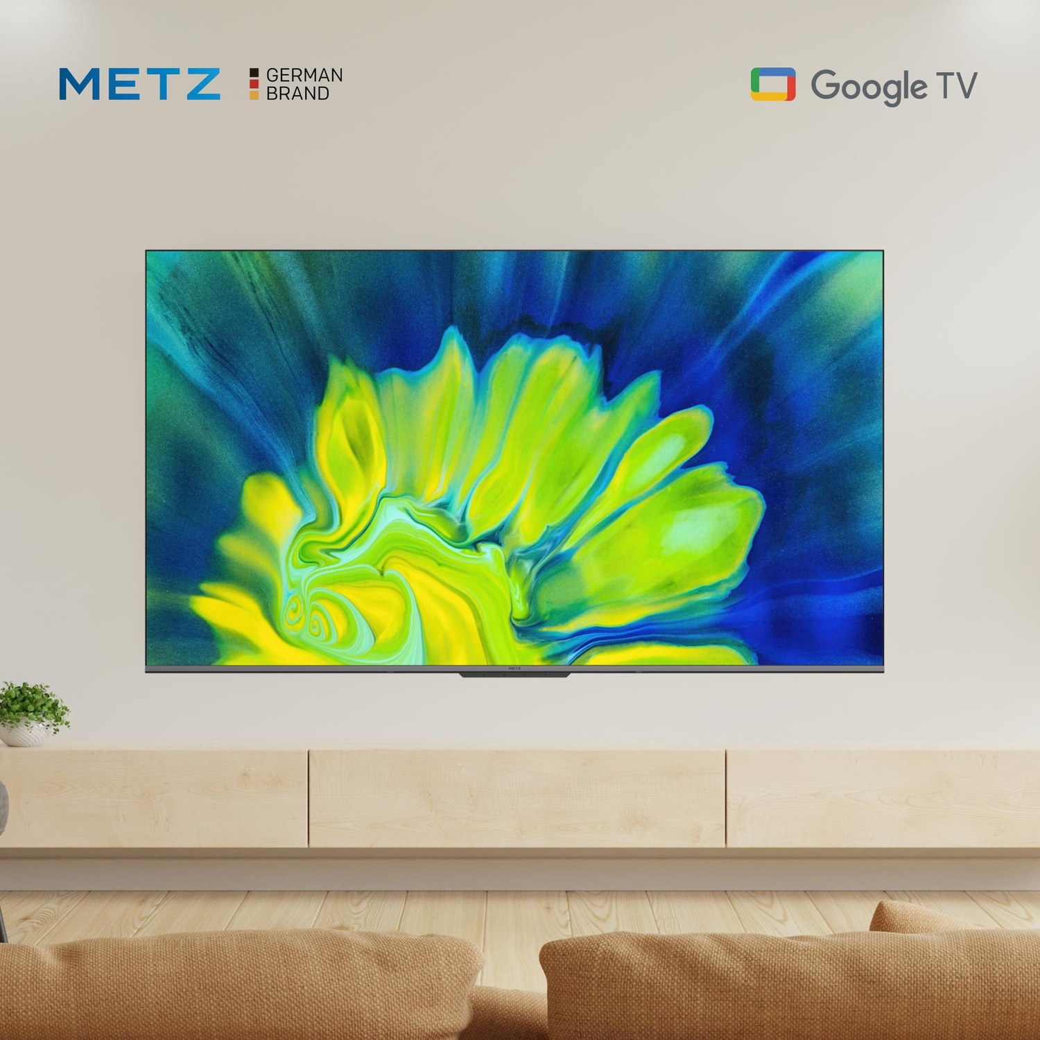 Un Google TV METZ con schermo astratto vivace, montato sopra un mobile in legno.