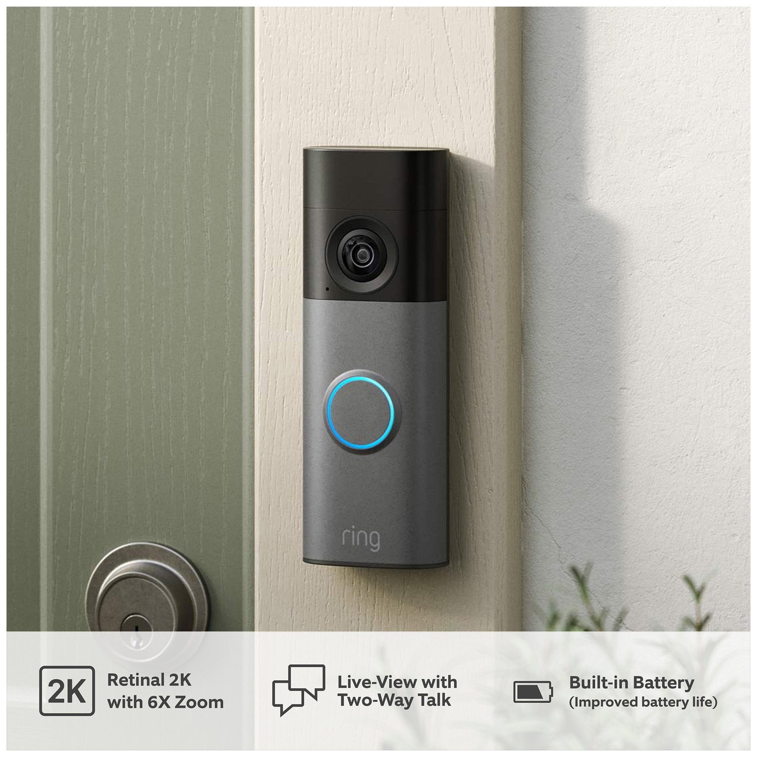 Ring doorbell on wall next to door. Features 2K zoom, two-way talk, battery.