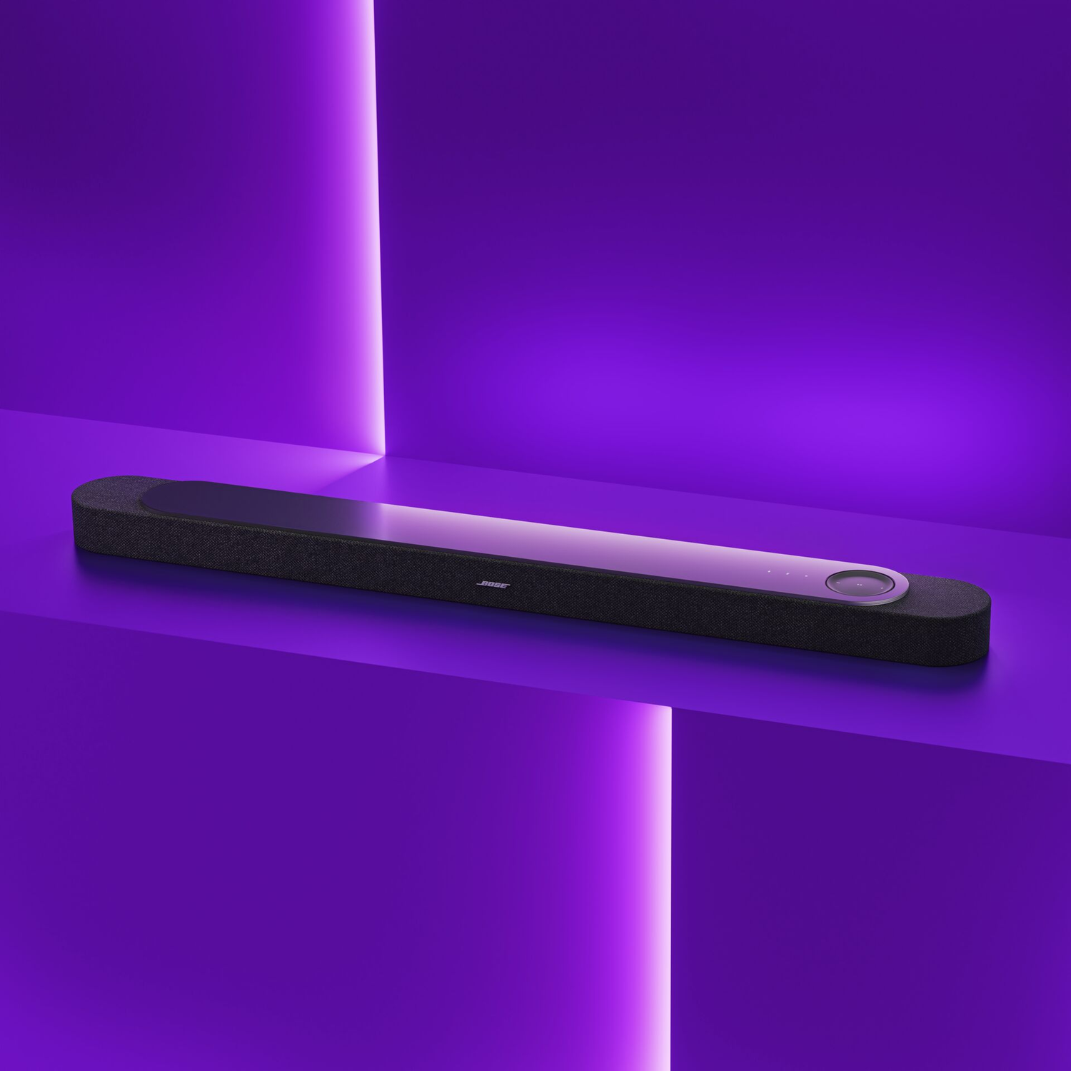 Black Bose speaker on a purple platform with purple lighting.