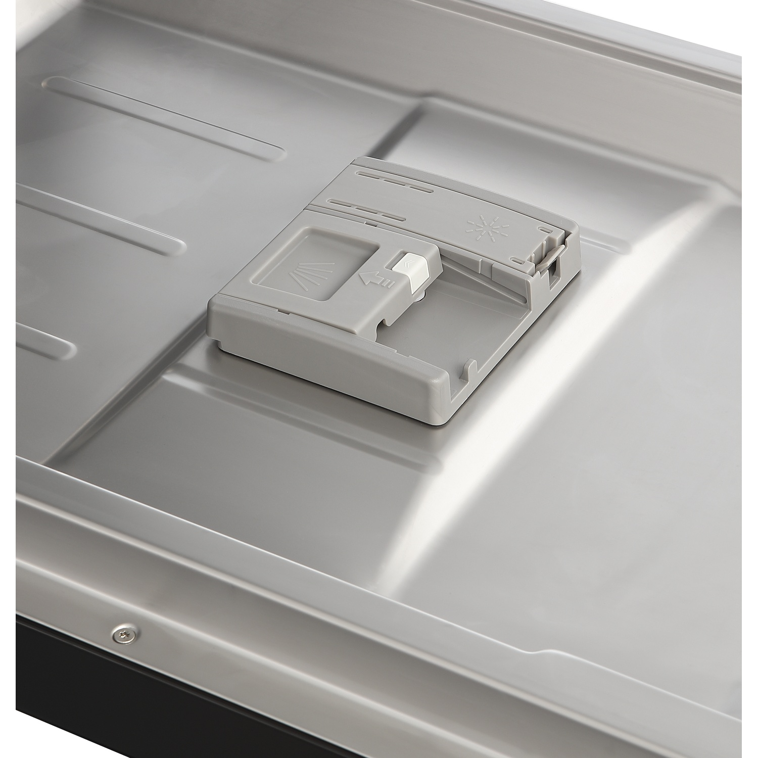 Gray detergent dispenser in a shiny metal tub with ridges.