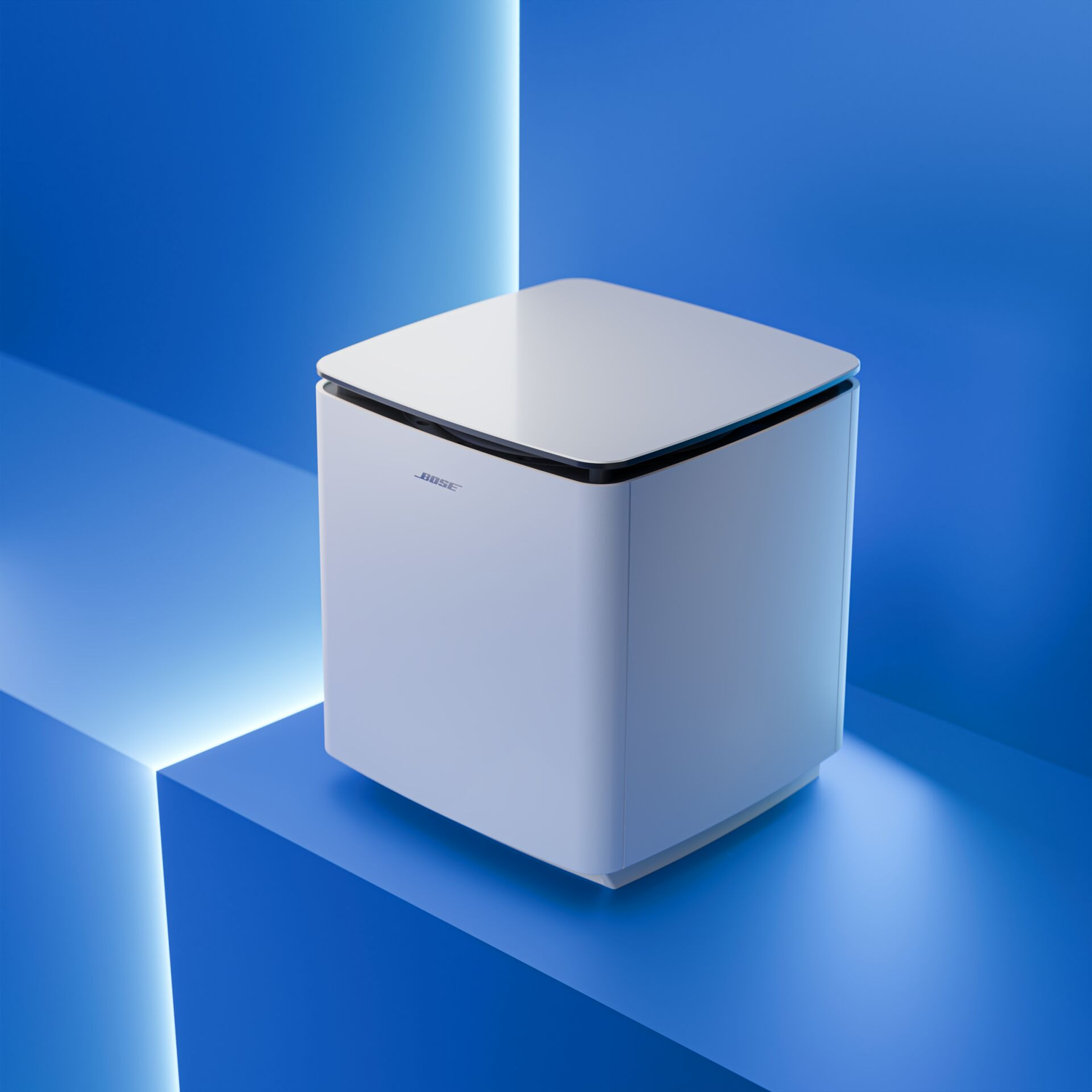 A white Bose subwoofer sits on a blue surface with light accents.
