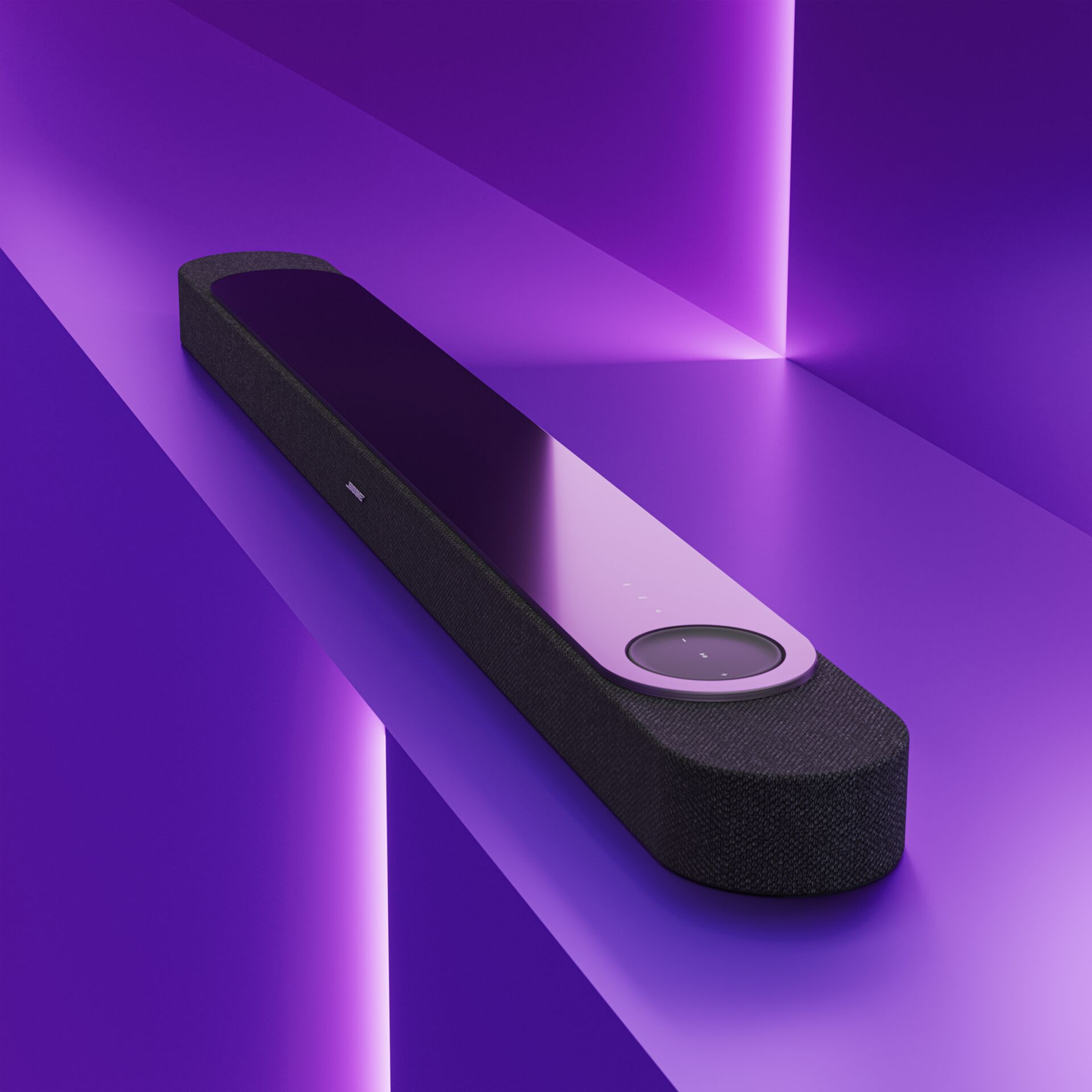 Une enceinte noire avec des accents violets sur une surface violette.