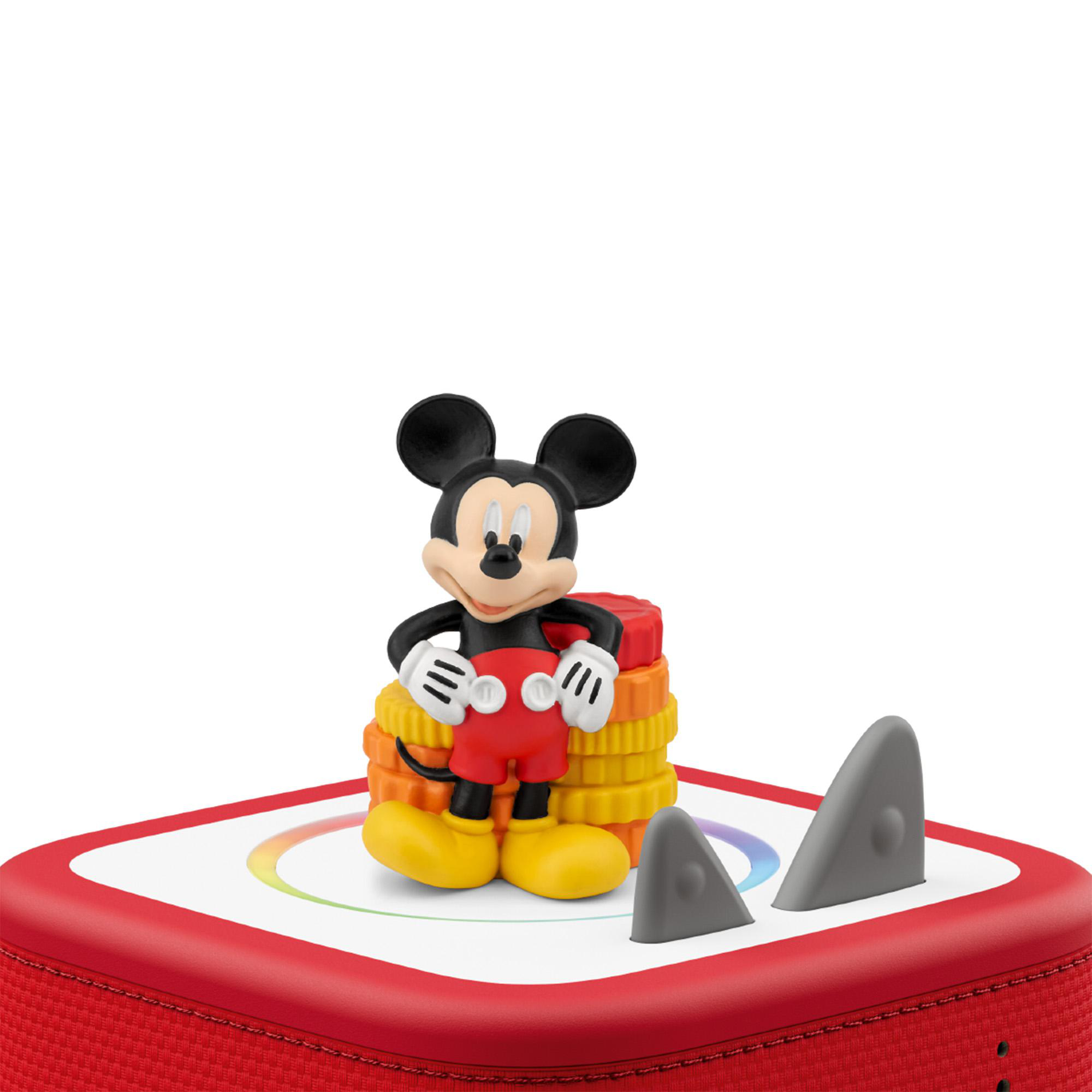 Micky Maus Figur auf bunten gestapelten Münzen auf rotem Gerät mit Haifischflossen.