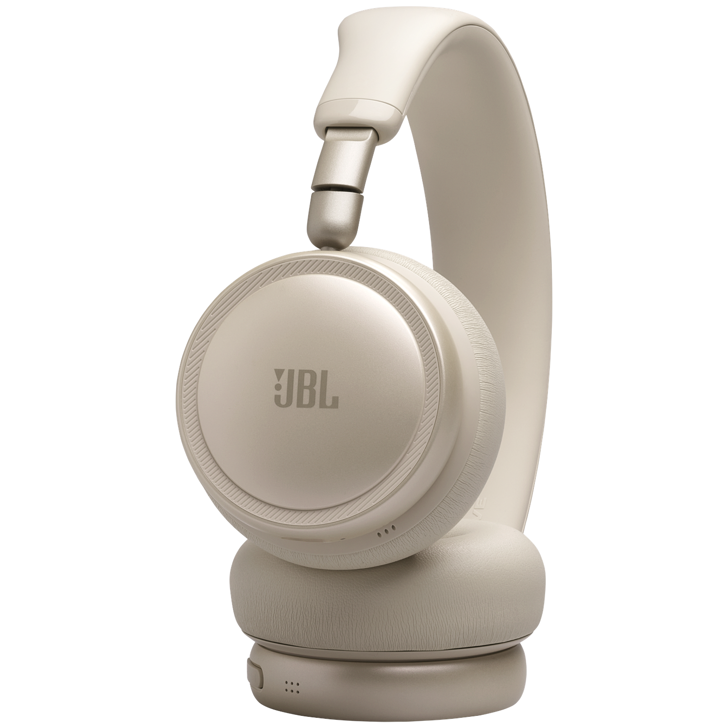 A beige JBL headphone with earcups and a headband.
