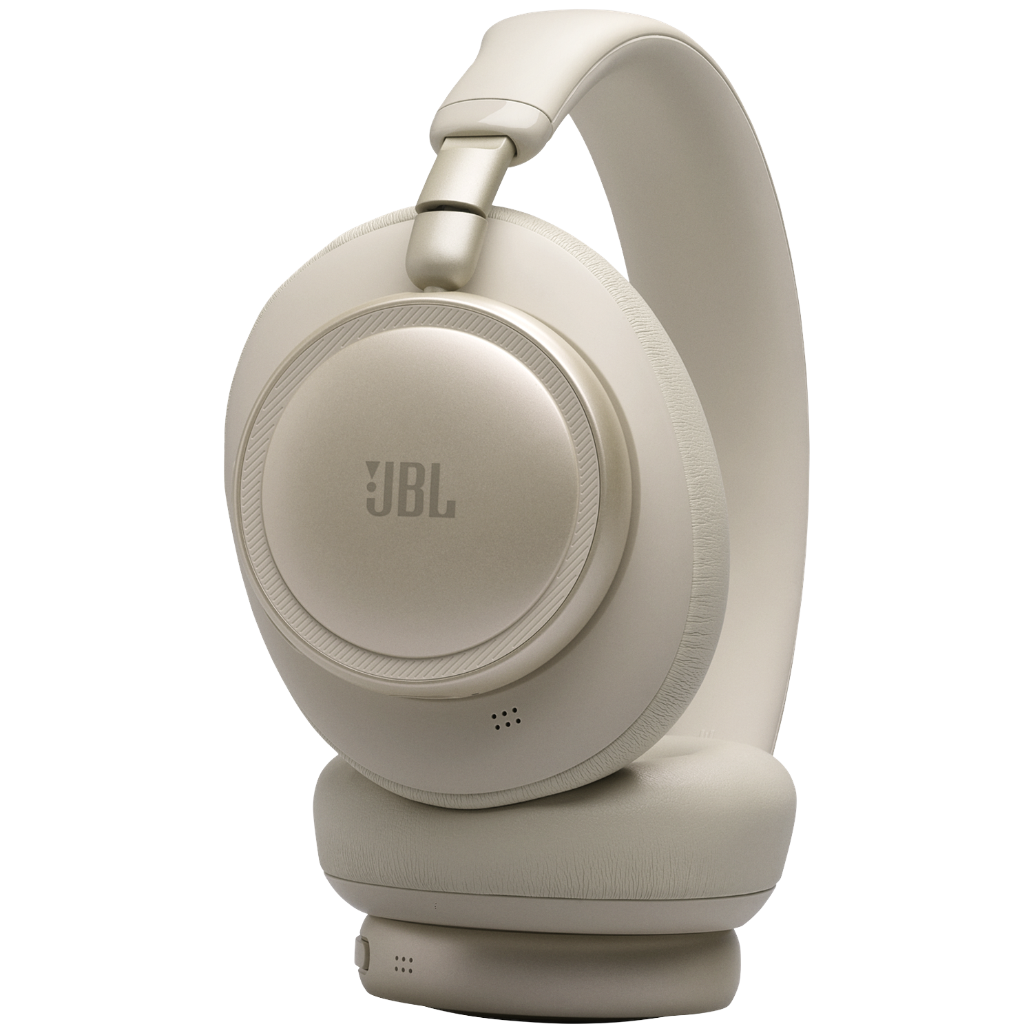 A close-up of a beige JBL headphone with a black background.