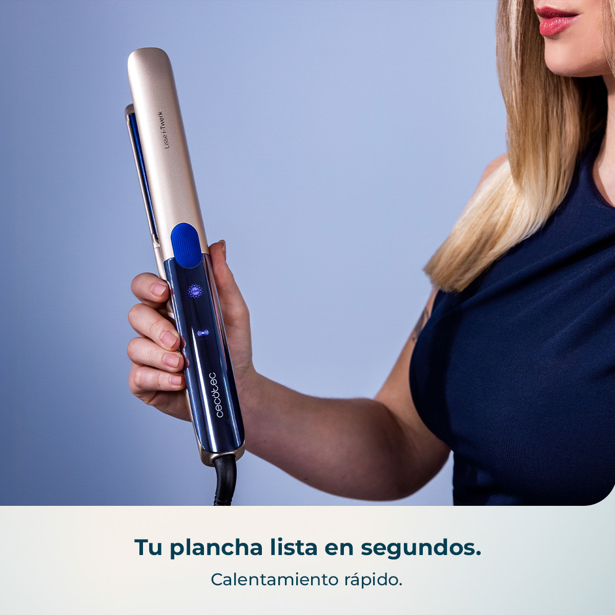 Una mano sostiene un rizador de pelo dorado con detalles azules y pantalla iluminada.