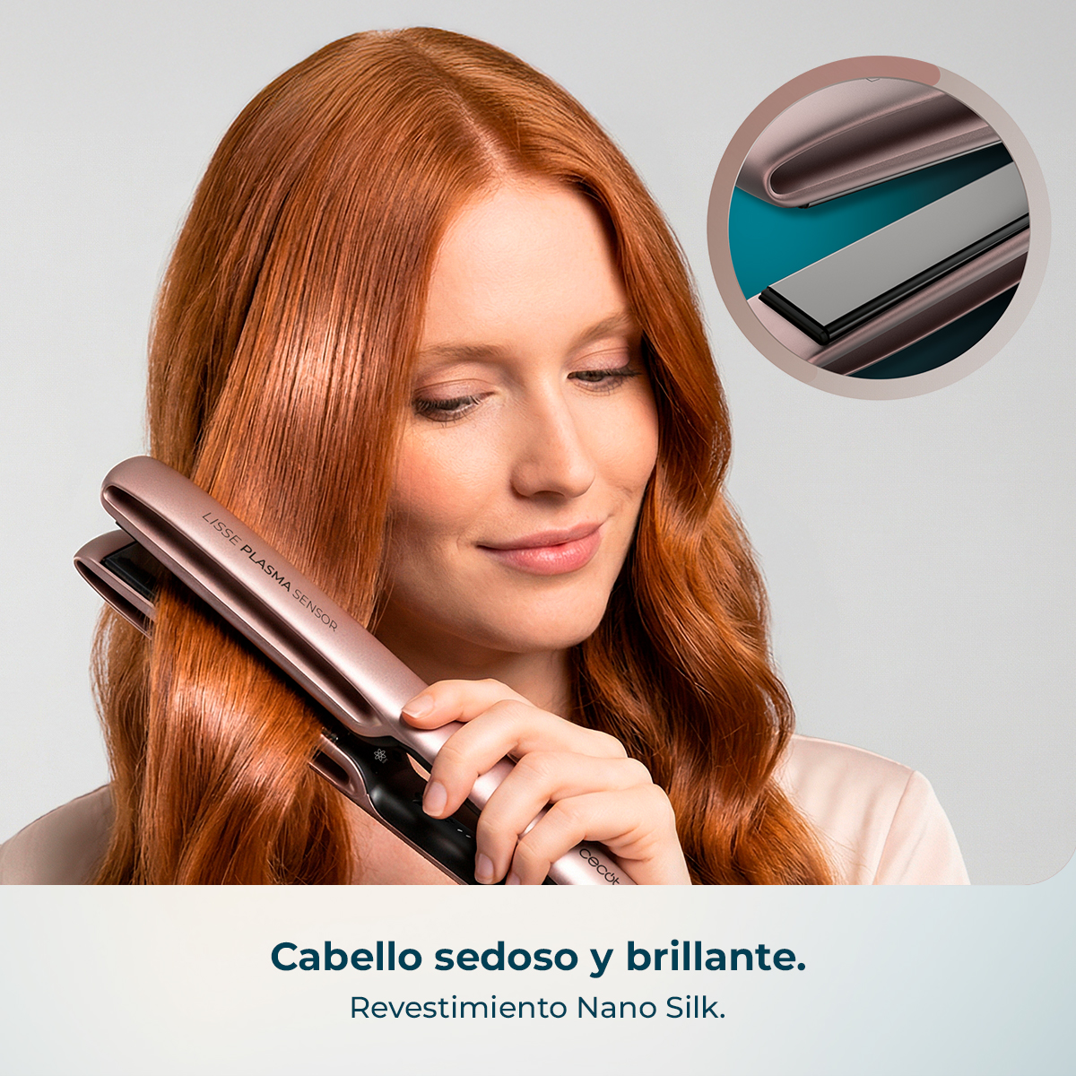 Mujer de pelo rojo alisando su cabello con una plancha rosa.