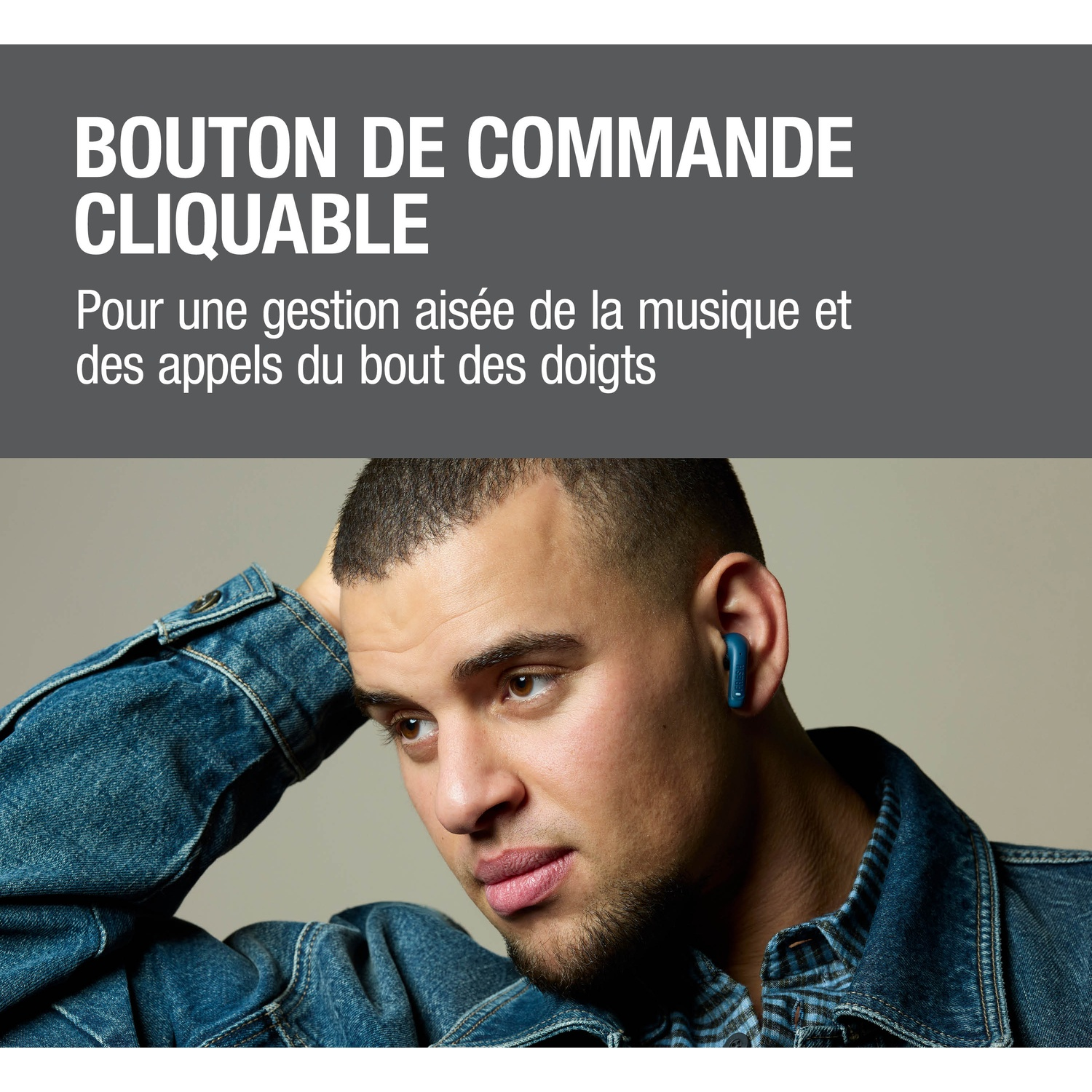 Homme avec un écouteur bleu dans l'oreille, portant une veste en jean.