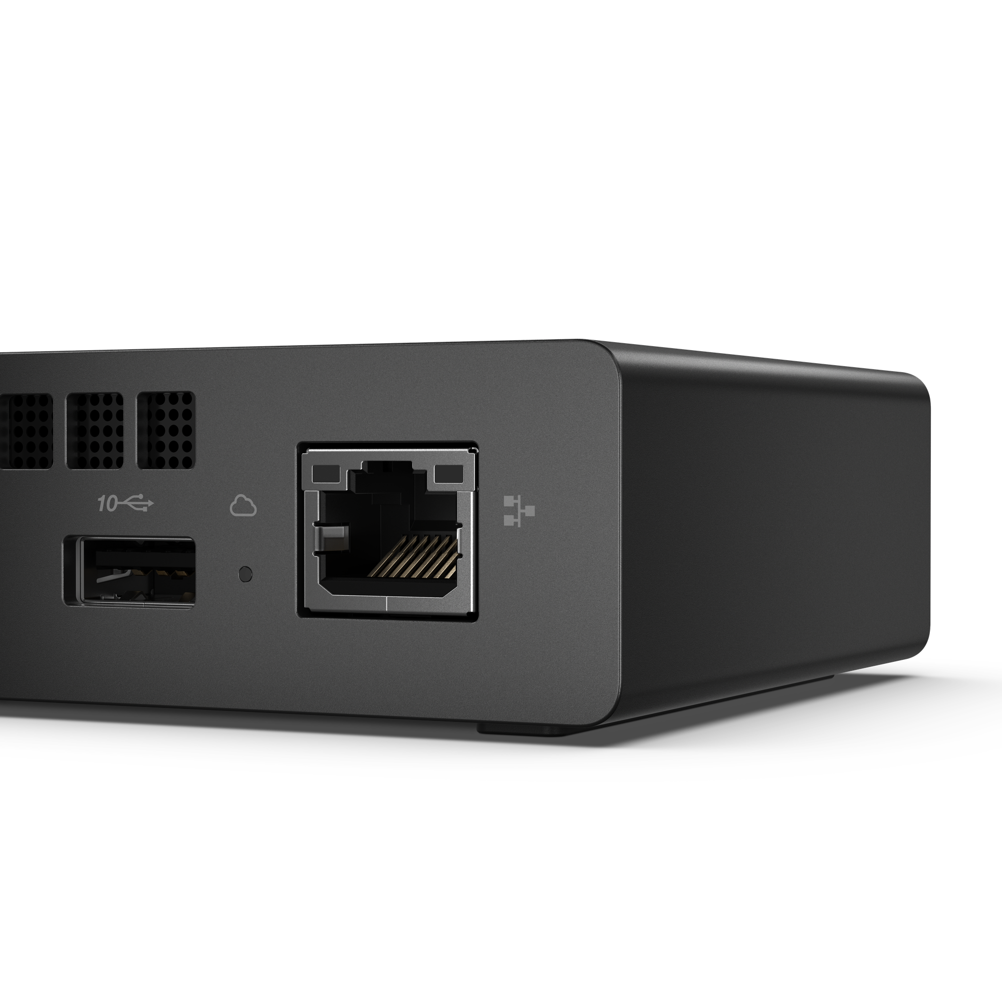 Mini dispositivo negro con puertos: USB, Ethernet, ranuras de ventilación.