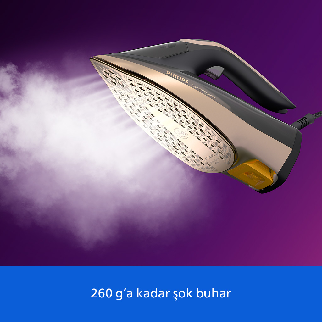 Altın rengi Philips ütü, mor arka plana karşı buhar yayıyor.