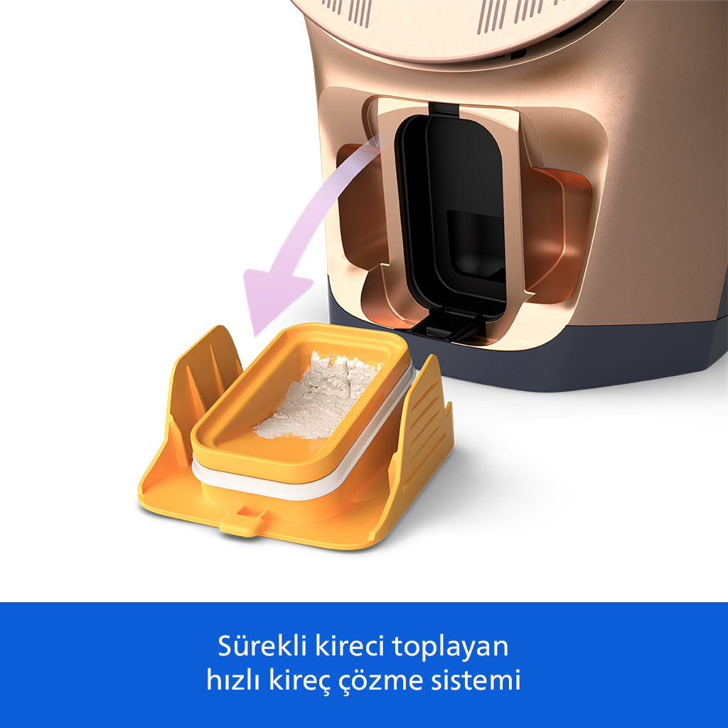 Bronz renkli bir cihazdan beyaz tozlu bir tepsi çekiliyor.